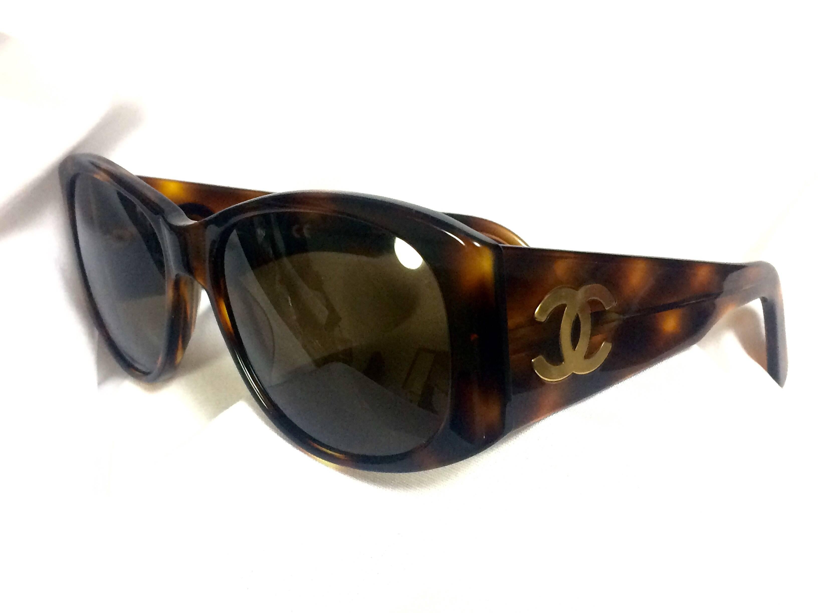 1990s. Vintage CHANEL brown frame sunglasses with large CC charms at sides. Mod and chic eyewear you must get.

This is a vintage CHANEL brown frame sunglasses that Lady Gaga also has! 
Retro and mod style are now in trend again! So you can enjoy