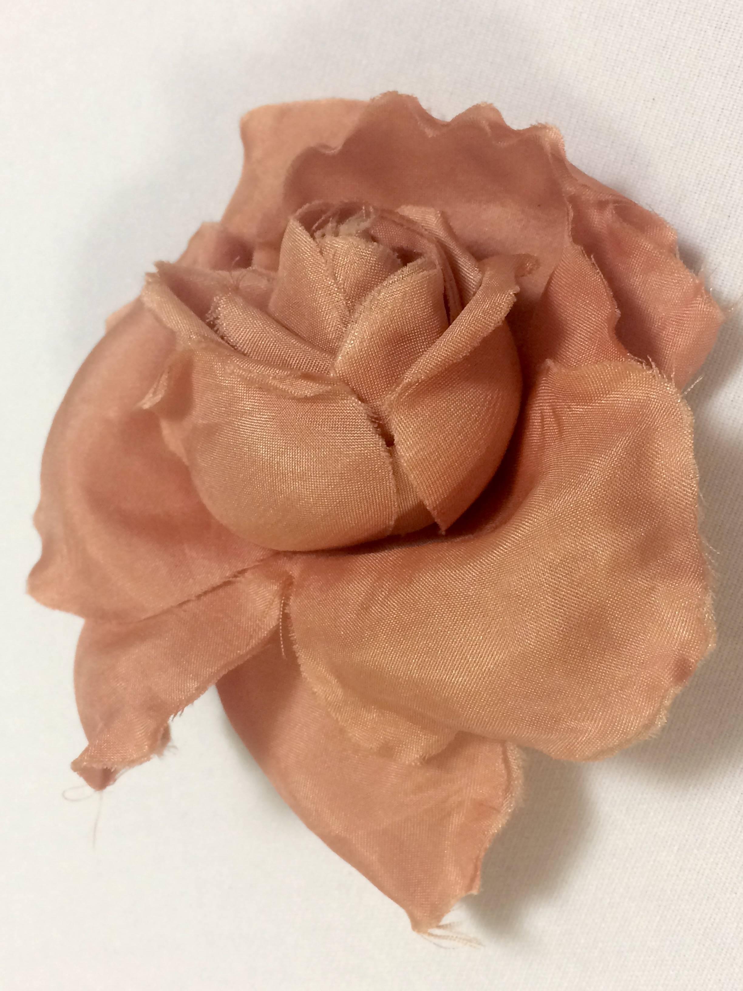 1990s. Vintage CHANEL salmon pink rose, flower silk brooch. Very elegant accent on your outfit. Classic jewelry for Spring and Summer.

Introducing an elegant brooch from CHANEL back in the 90's. Great gift idea. Free gift wrapping. 
Beautiful silk