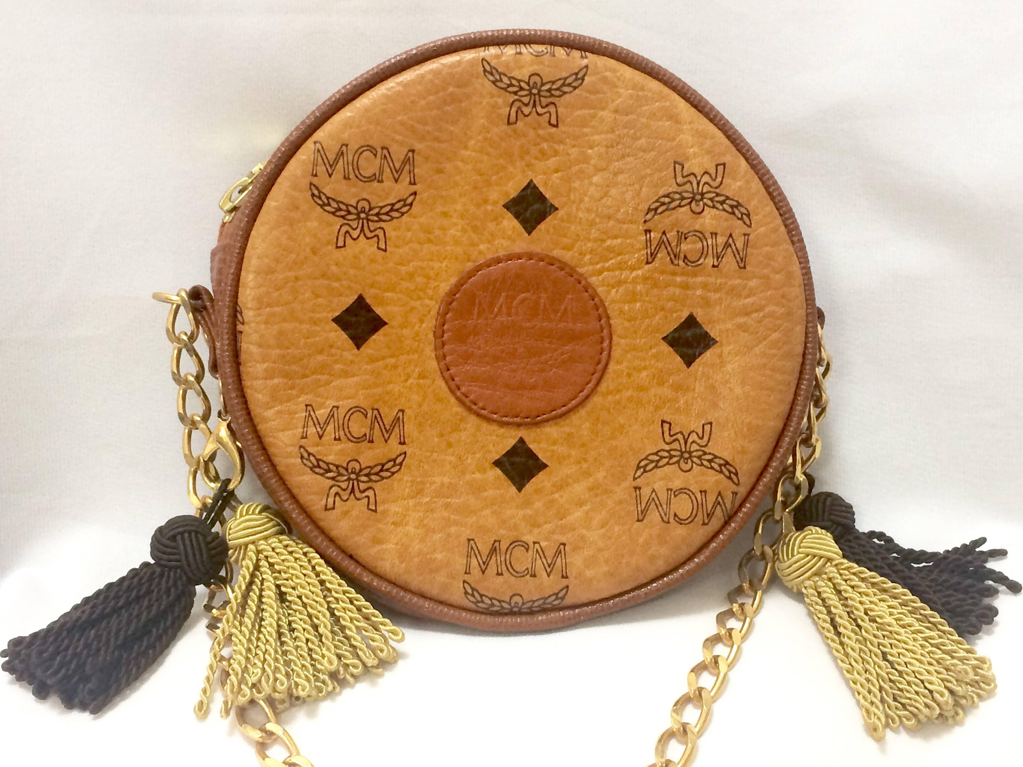 1980s. MINT. Vintage MCM brown monogram round shape mini chain shoulder purse with brown and beige fringes. Designed by Michael Cromer. Made in West Germany.

MCM has been back in the fashion trend again!!
Now it's considered to be one of the