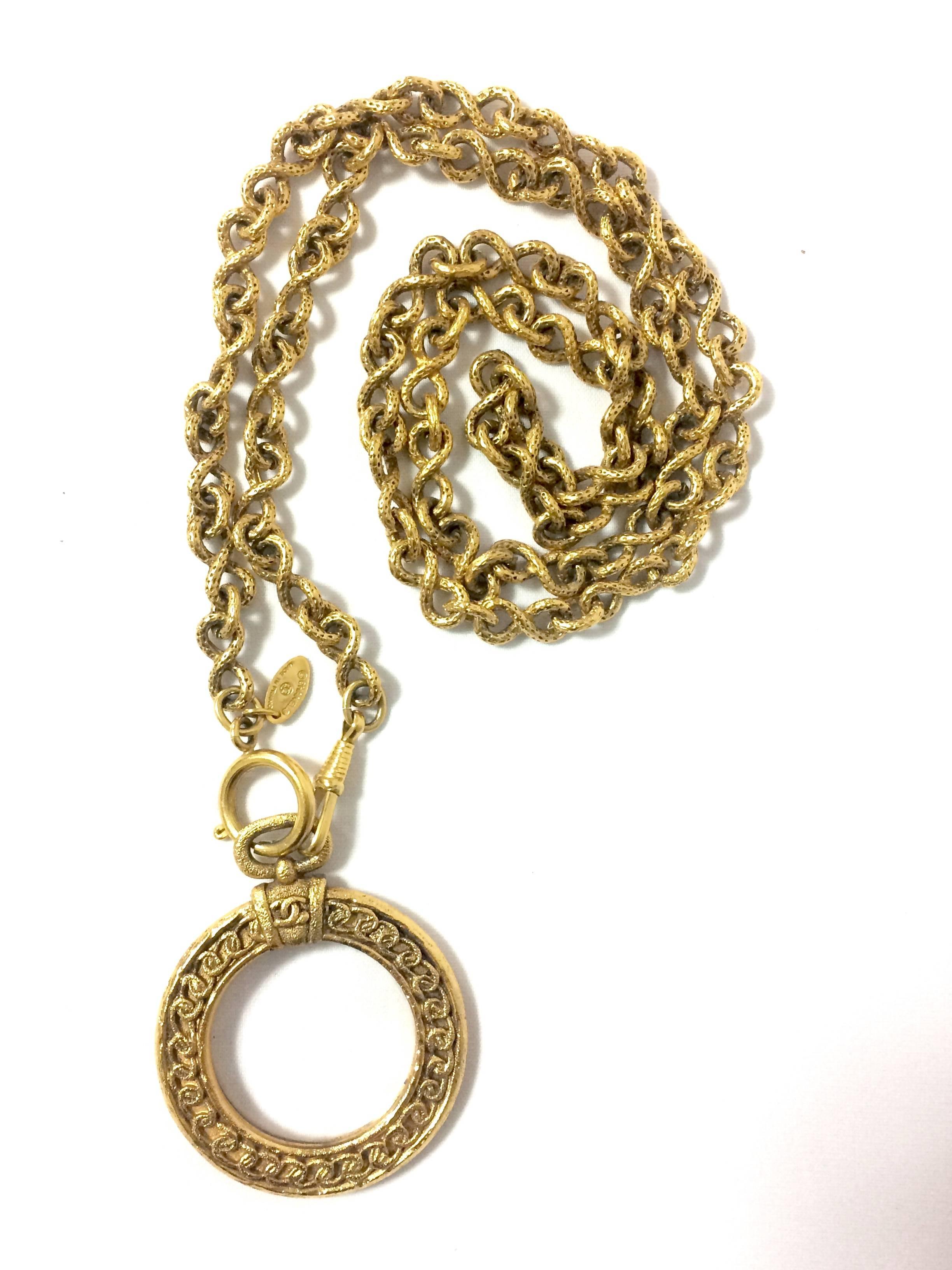 Vintage CHANEL long chain necklace with round glass loupe pendant top and CC. 4
