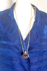 Vintage Gucci gold and navy round shape perfume bottle necklace with logo mark.