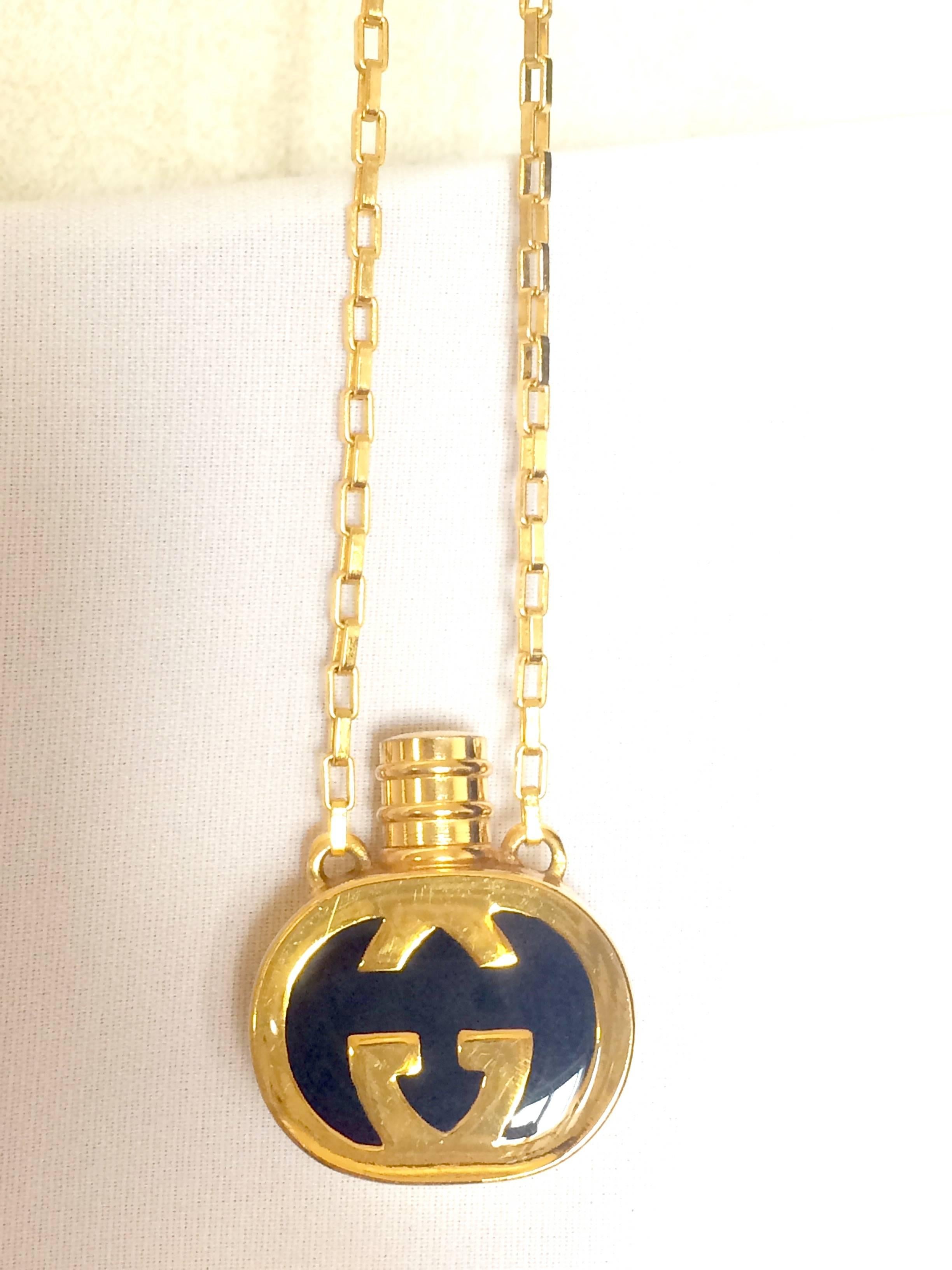 Vintage Gucci gold and navy round shape perfume bottle necklace with logo mark. 1