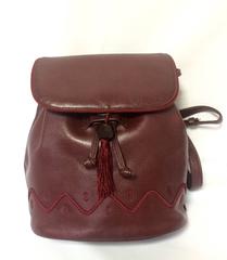 Vintage MOSCHINO dark wine leather backpack with tassel and logo embroidery.