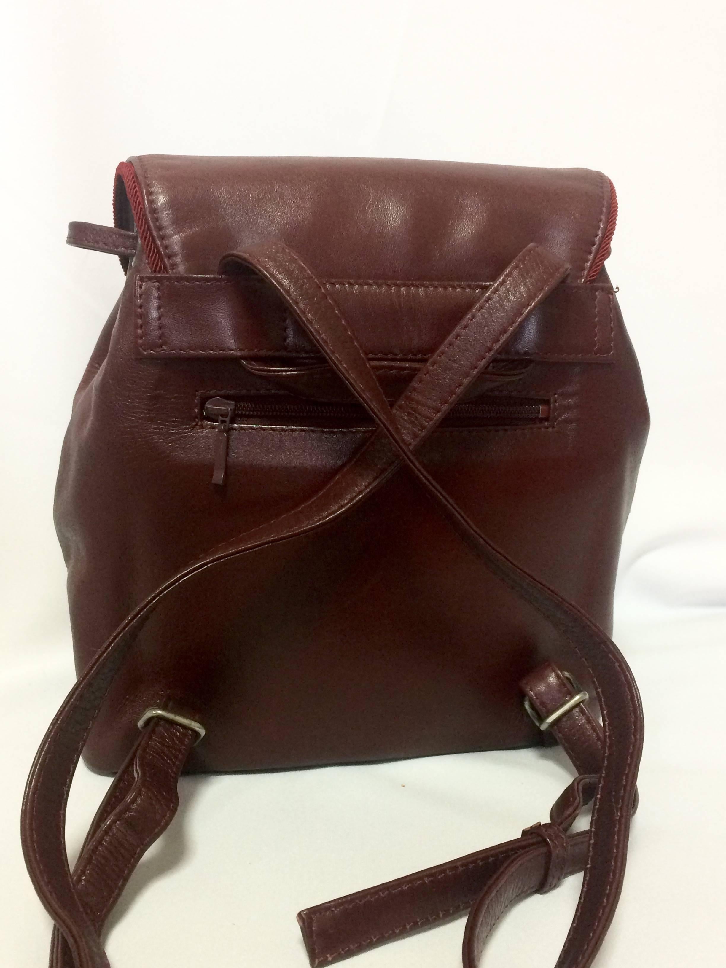 Brown Vintage MOSCHINO dark wine leather backpack with tassel and logo embroidery. For Sale