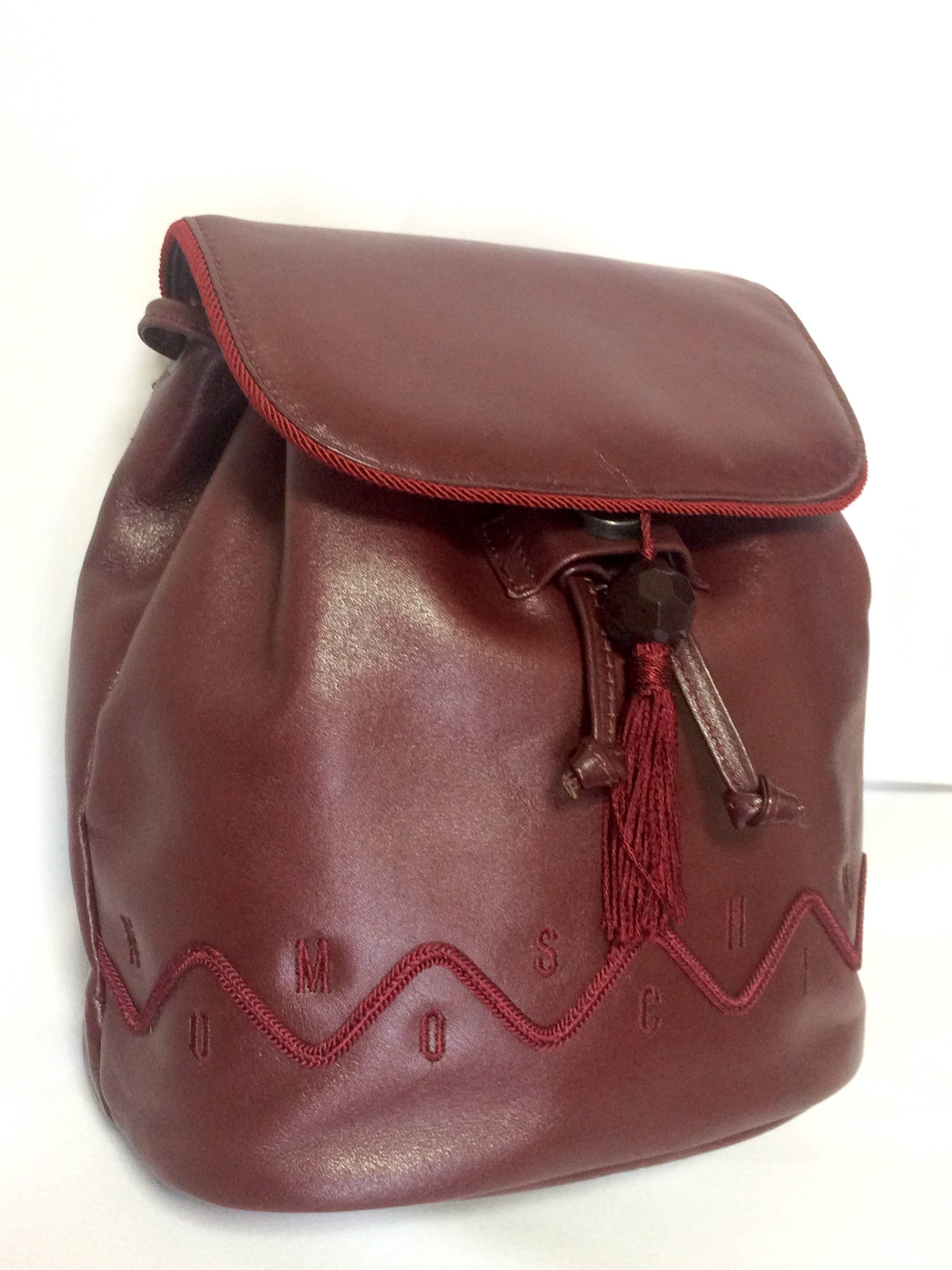 Vintage MOSCHINO dark wine leather backpack with tassel and logo embroidery. In Excellent Condition For Sale In Kashiwa, Chiba
