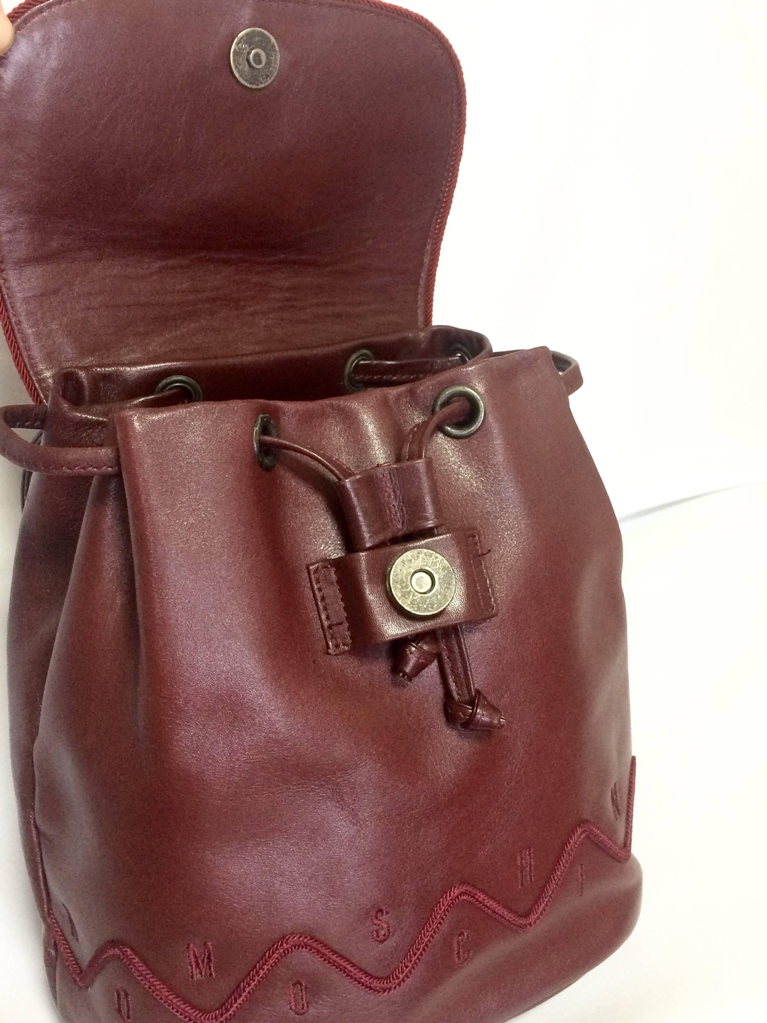 Vintage MOSCHINO dark wine leather backpack with tassel and logo embroidery. For Sale 3