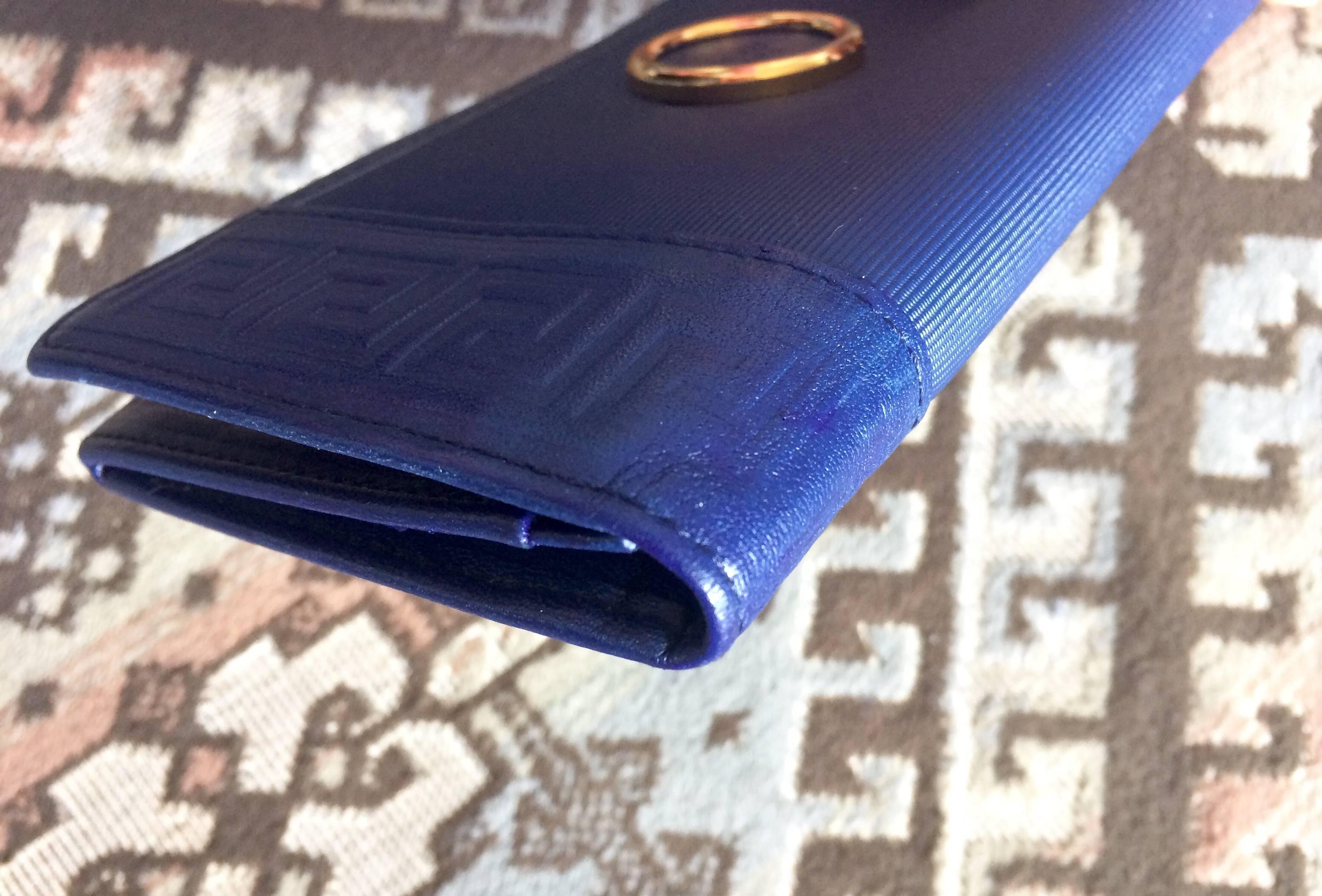 Blue Vintage Gianni Versace blue wallet with geometric pattern and logo round motif.