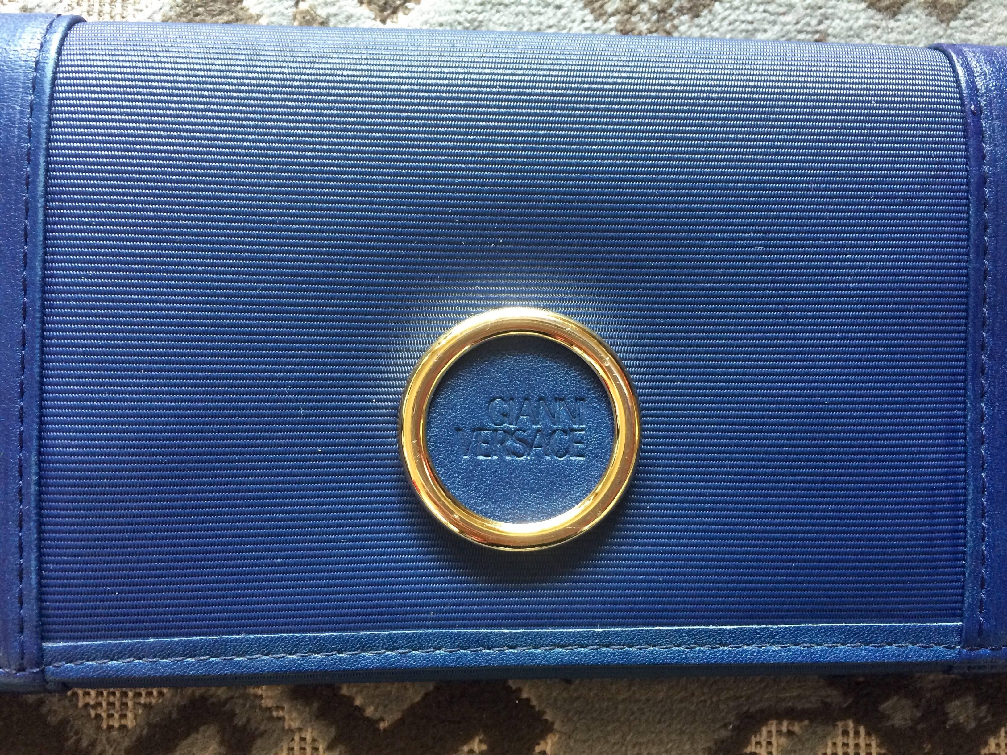 1990s. Vintage Gianni Versace blue wallet with its iconic geometric pattern and a golden round embossed logo motif. Unisex great gift.

For all Gianni Versace vintage lovers, this early 90's vintage bill wallet is the one for you.
You will love its
