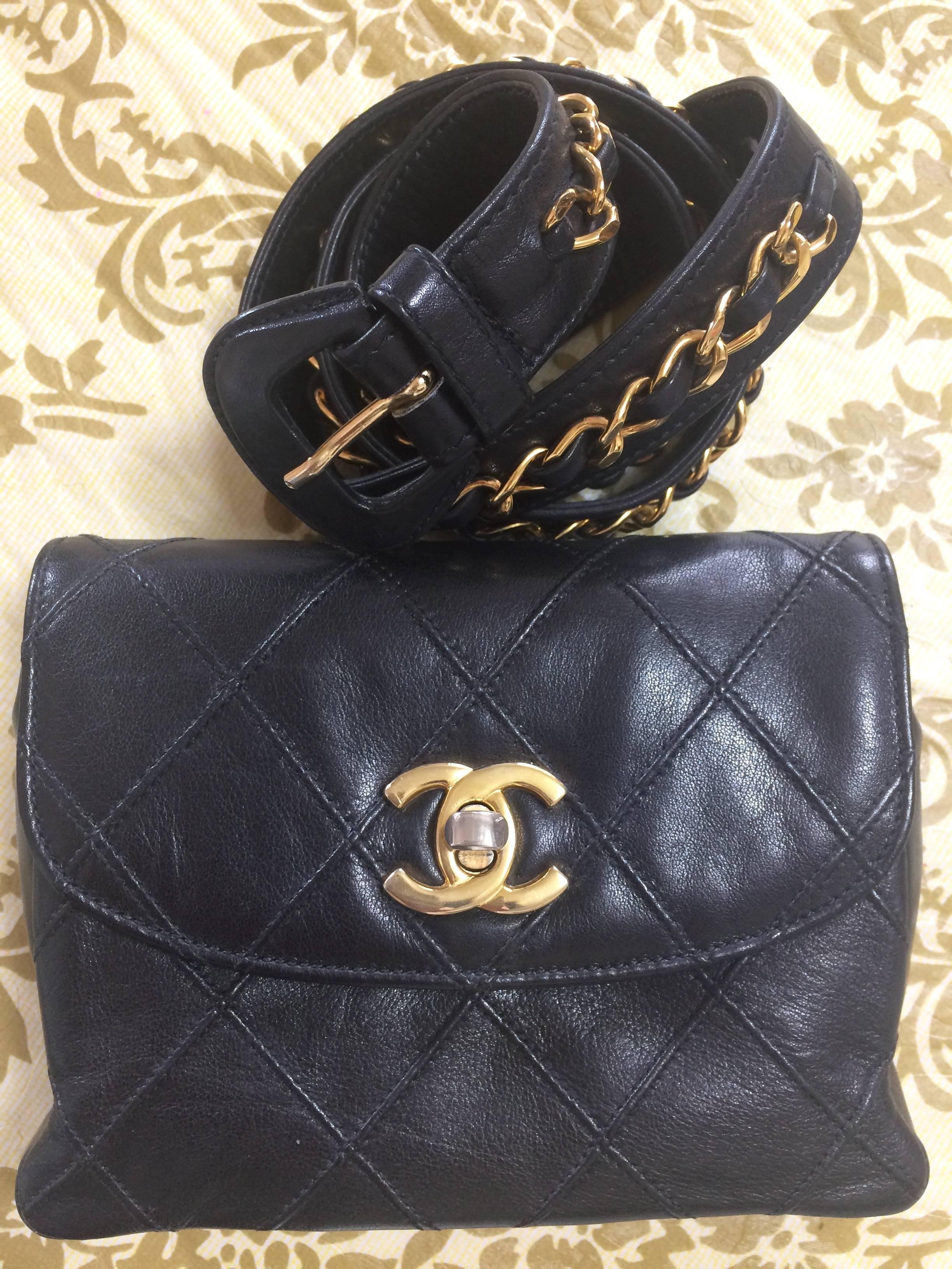 Black Vintage CHANEL black waist purse, fanny bag with golden chain belt and CC mark.