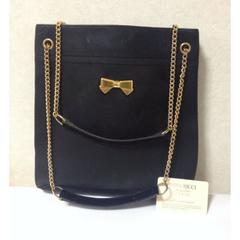 Vintage Nina Ricci black tote bag with golden chain straps with golden logo bow.