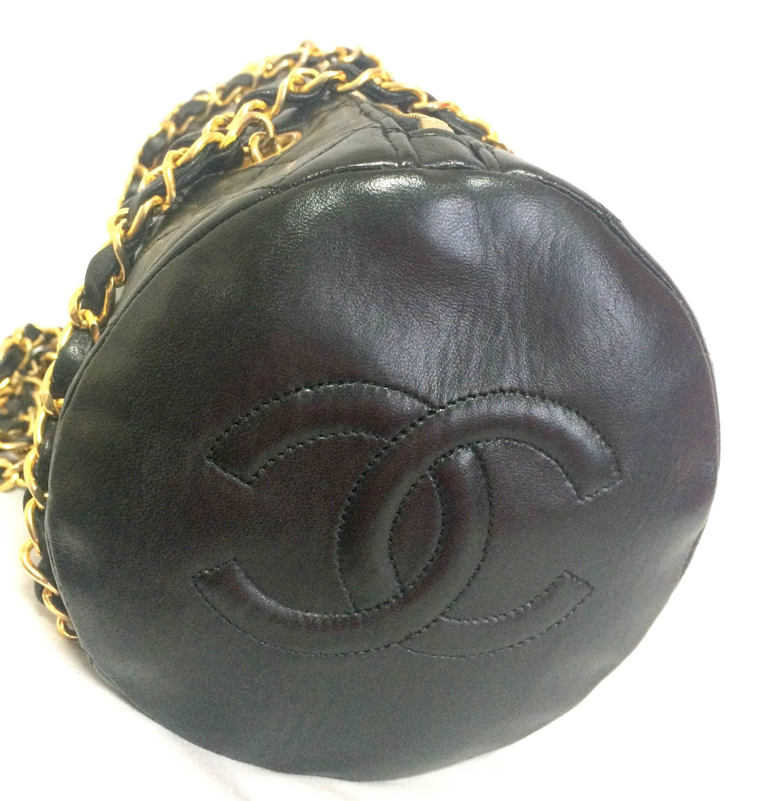 1980s-90s. Vintage CHANEL black lamb leather golden chain shoulder bag in round drum shape with CC marks. Must have purse.

Introducing one of the most popular bags from CHANEL back in the late 80"s early 90's, a drum shape lambskin shoulder