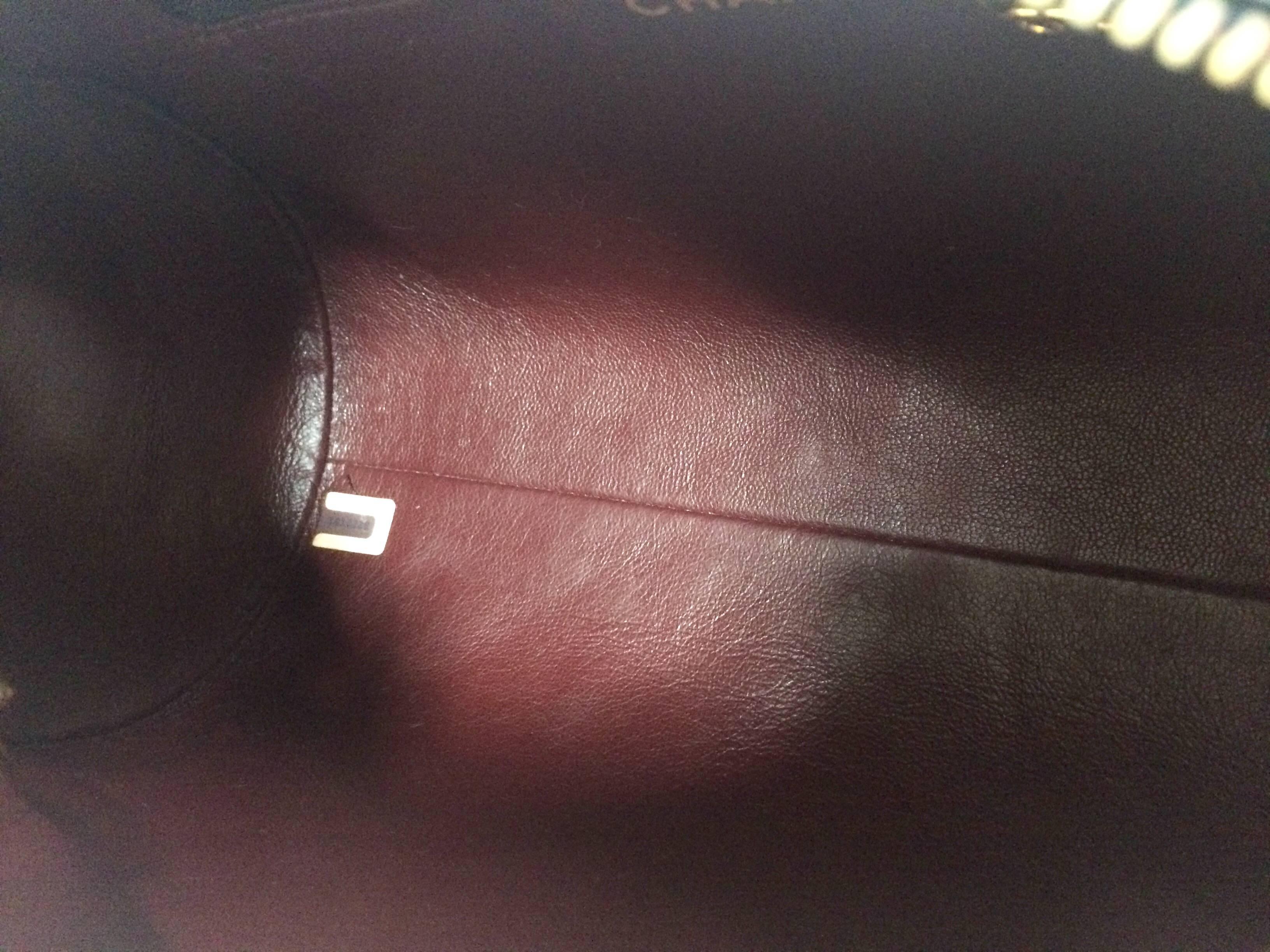 Vintage CHANEL black lamb leather golden chain shoulder bag in round drum shape. 2