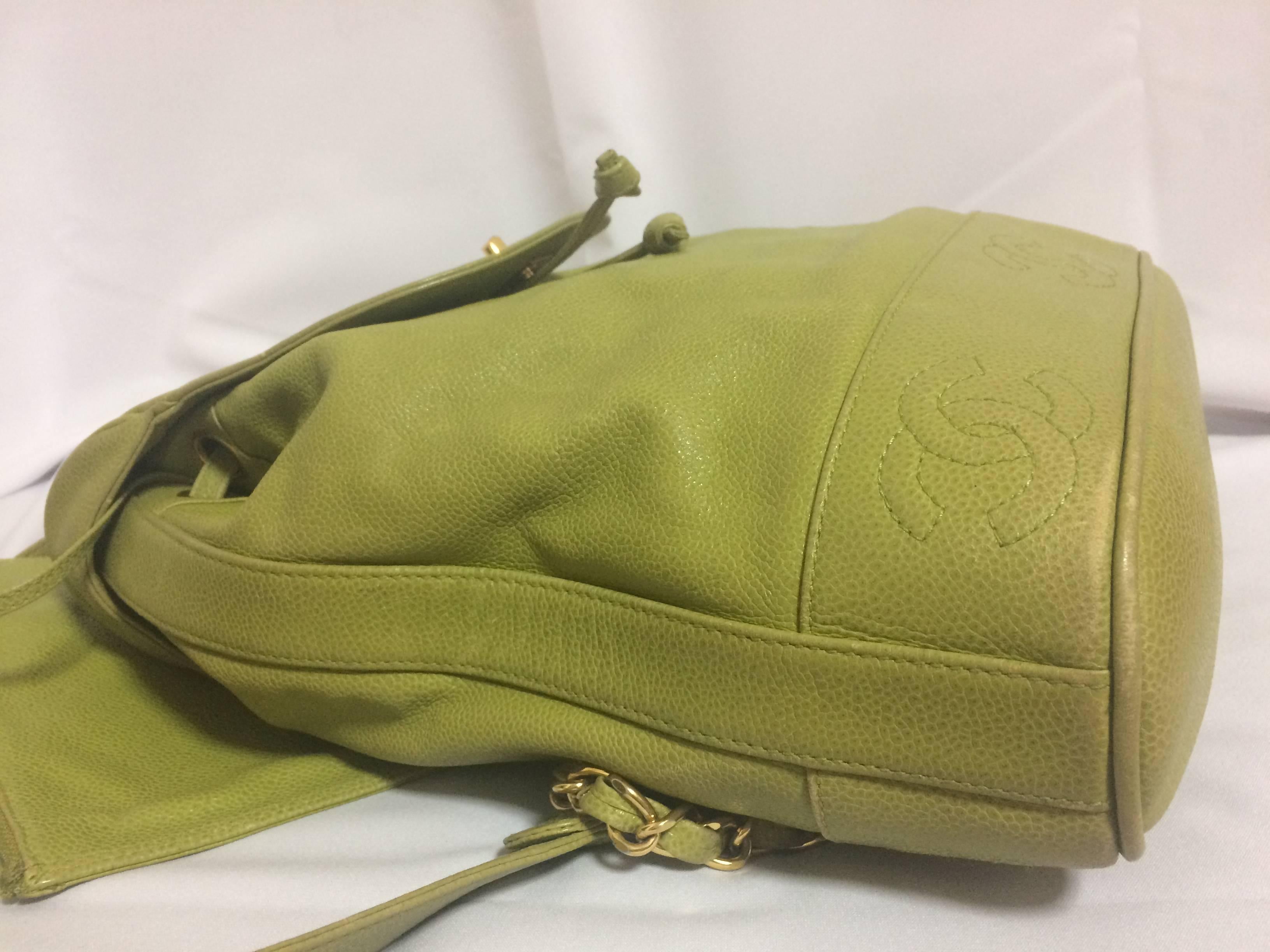 Brown Vintage CHANEL green caviar leather backpack with gold chain strap and CC motif. For Sale