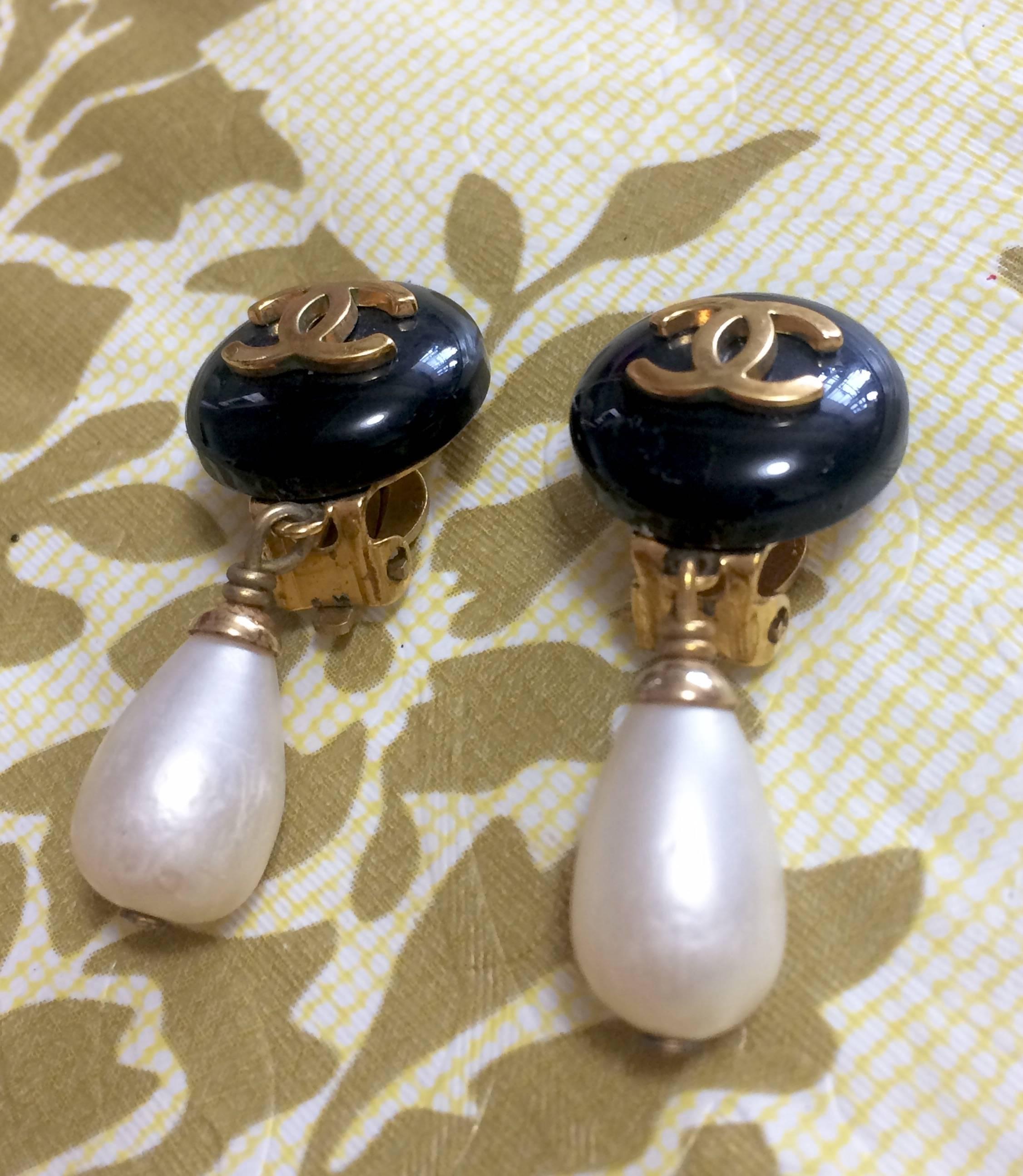 Women's Vintage CHANEL teardrop white faux pearl earrings with black and golden CC mark. For Sale