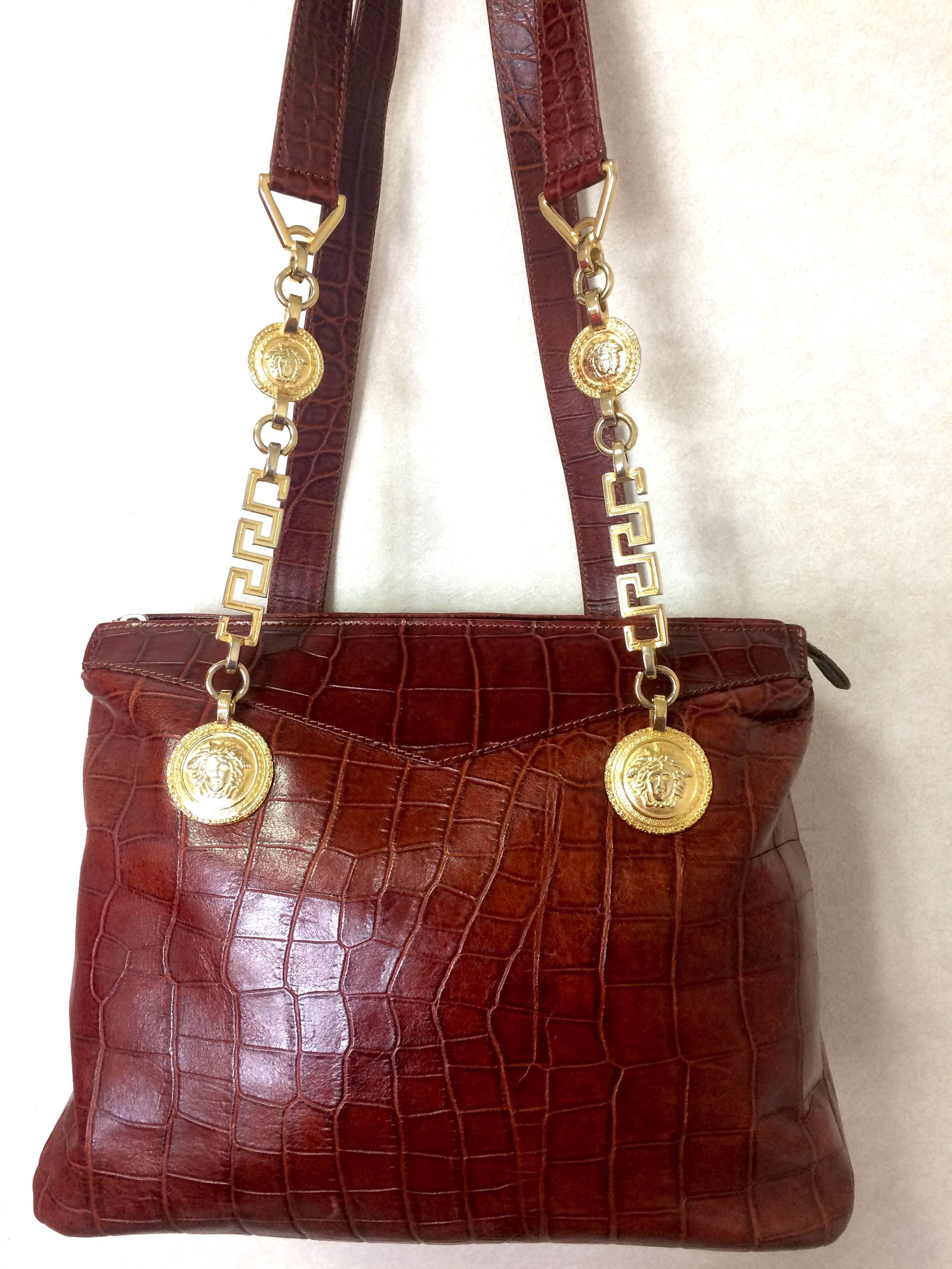 1990s. Vintage Gianni Versace brown croc-embossed leather shoulder tote bag with golden hardware and medusa charms.

Introducing another rare vintage masterpiece from Gianni Versace back in the 90's.
If you are looking for vintage masterpiece from