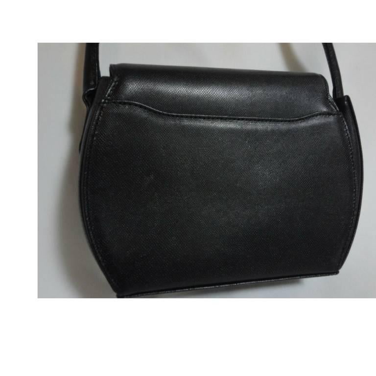 Black Vintage MOSCHINO black leather handbag, oval shape purse with golden logo motif. For Sale