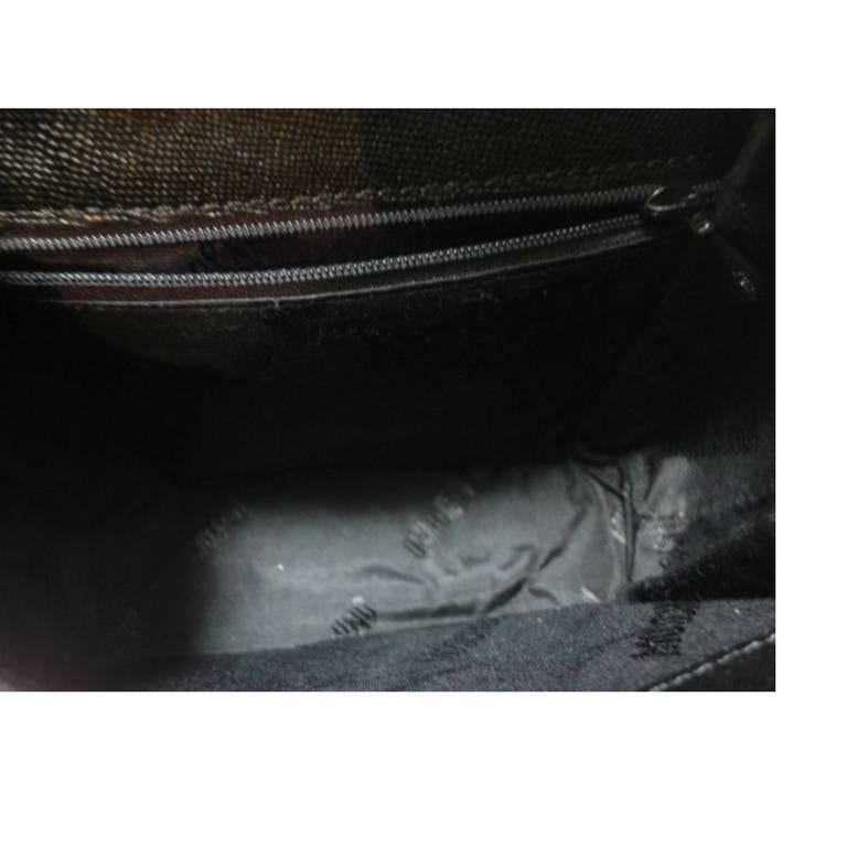 Vintage MOSCHINO black leather handbag, oval shape purse with golden logo motif. For Sale 2