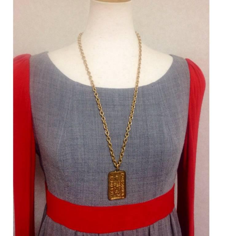 1990. MINT. Vintage Moschino long chain classic necklace with large square plate with embossed logo, heart and love and peace mark.

Introducing another chic and mod necklace from MOSCHINO back in the 90's.
It is a gorgeous chest-long chain necklace