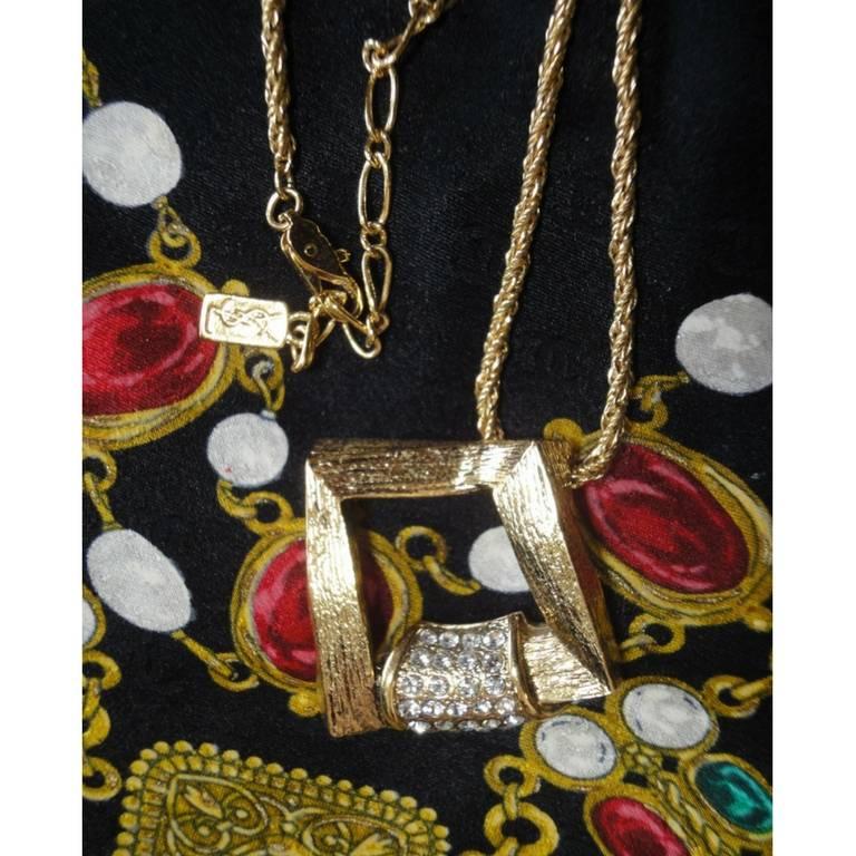 1990s. MINT. Vintage Yves Saint Laurent, YSL skinny chain necklace with outlined square pendant top with crystal stones.

Introducing another fabulous necklace from Yves Saint Laurent approx from the early 90s.
If you are a vintage YSL lover or