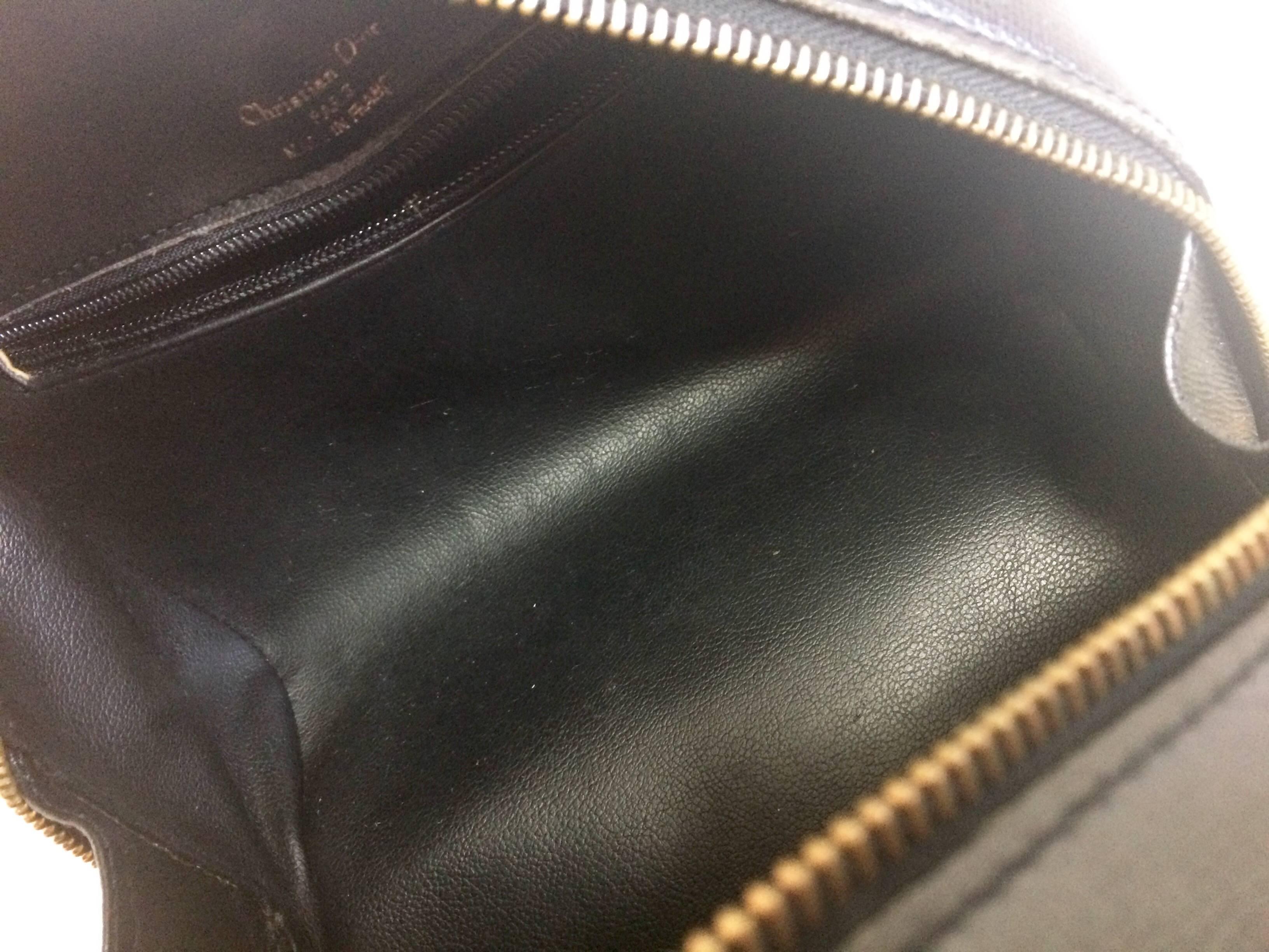 Vintage Christian Dior grained black leather handbag with oval golden CD logo.  For Sale 1