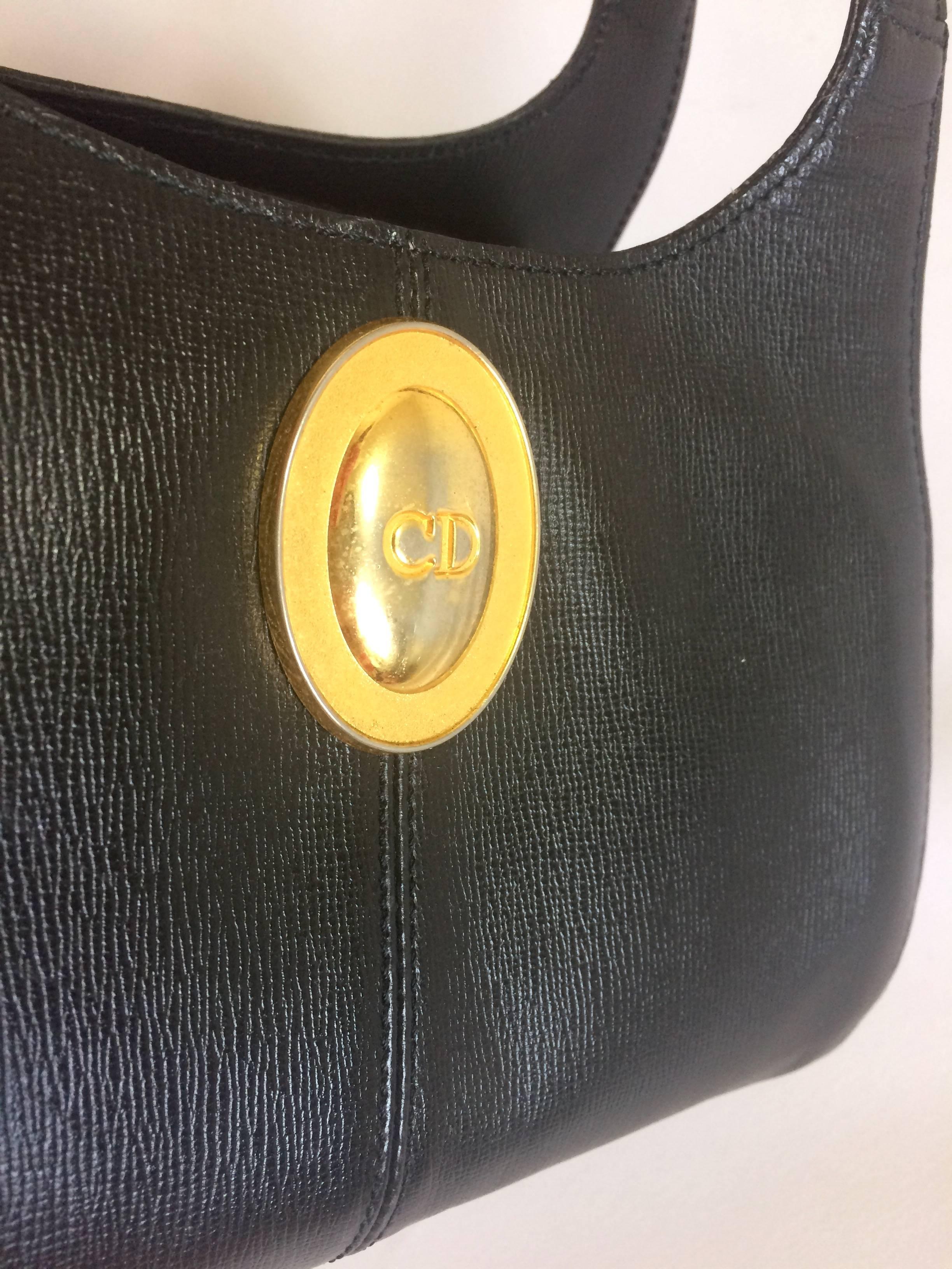 Black Vintage Christian Dior grained black leather handbag with oval golden CD logo.  For Sale