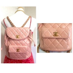 Vintage CHANEL quilted pink lamb leather backpack with golden chains and CC mark