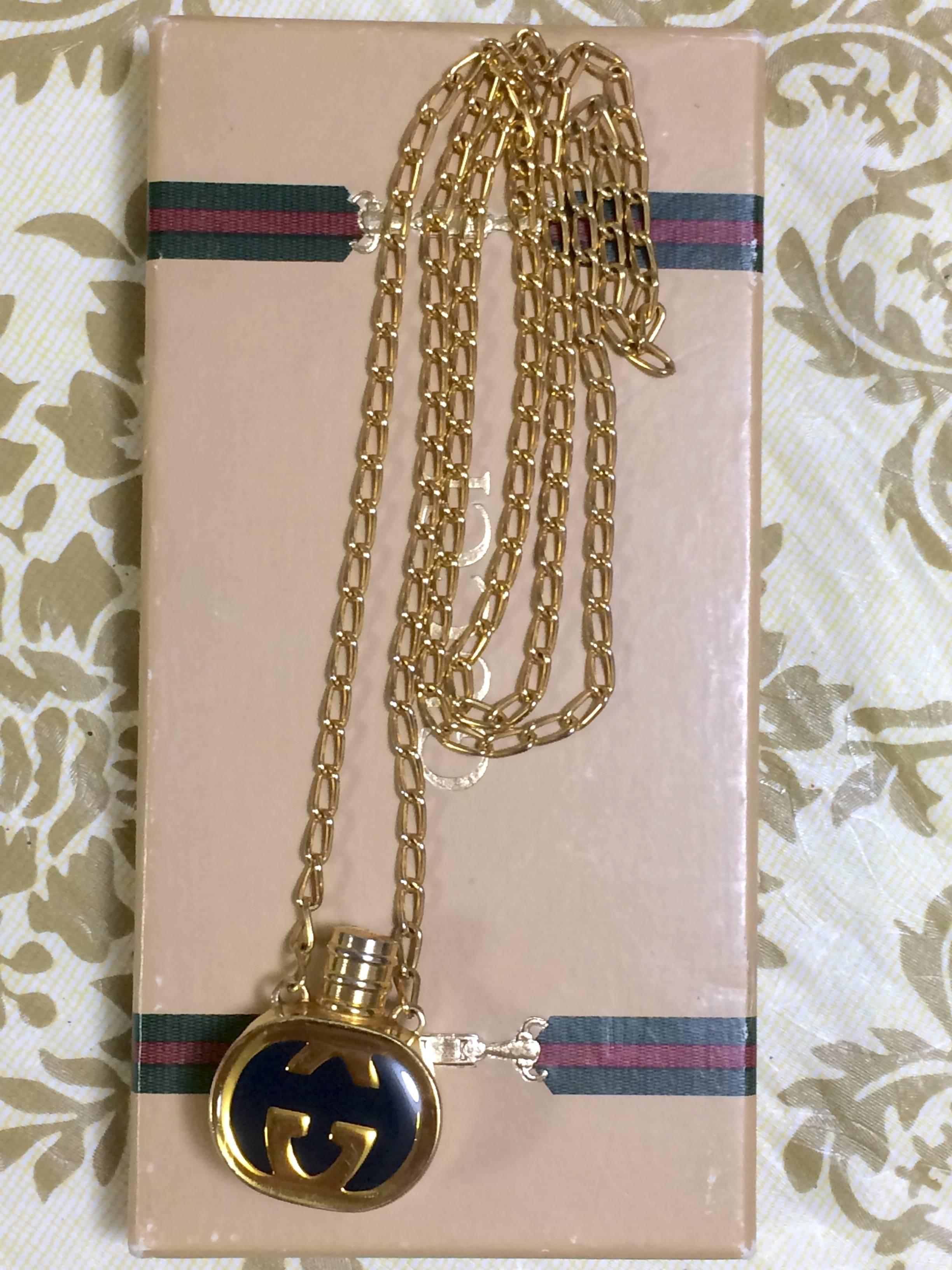 Women's or Men's Vintage Gucci gold and navy round shape perfume bottle necklace with iconic logo