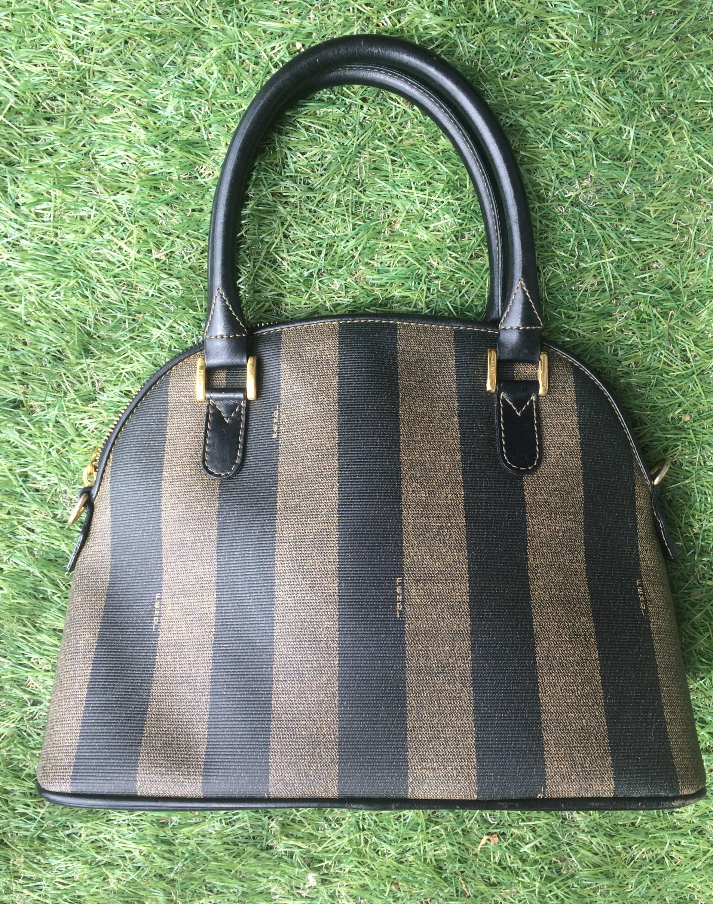1990s. Vintage FENDI classic black and grey pecan vertical stripe bolide shape handbag with leather handles. Classic bag for daily use.

This is a FENDI conic pecan pattern purse in bolide shape from the early 90's. 
Very classic and yet