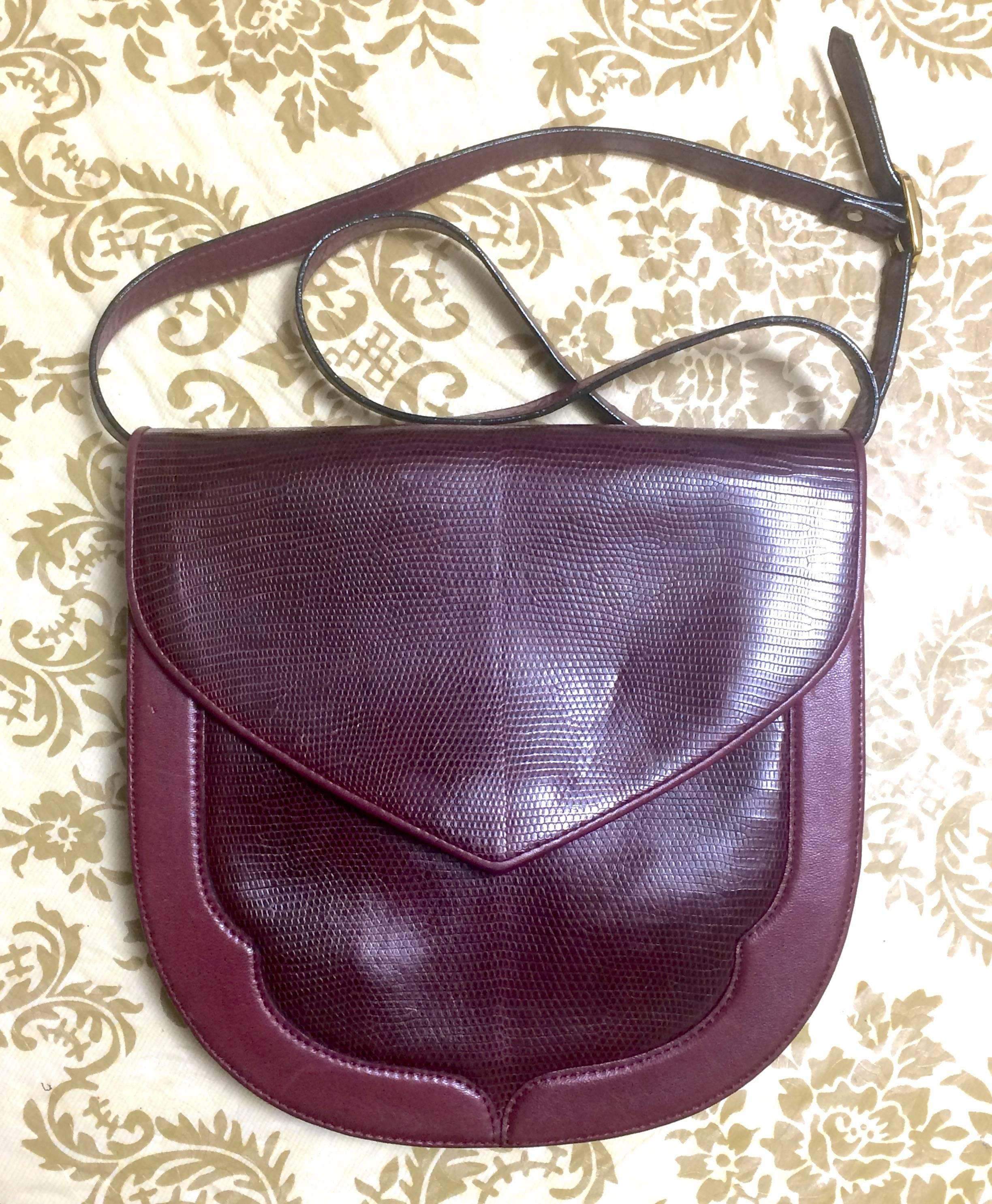 1980's Vintage Yves Saint Laurent wine red, bordeaux lizard and leather shoulder clutch bag with YSL logo interior linings.

This is a vintage shoulder purse from Yves Saint Laurent approx from the 80's.
You will love and use this unique form in