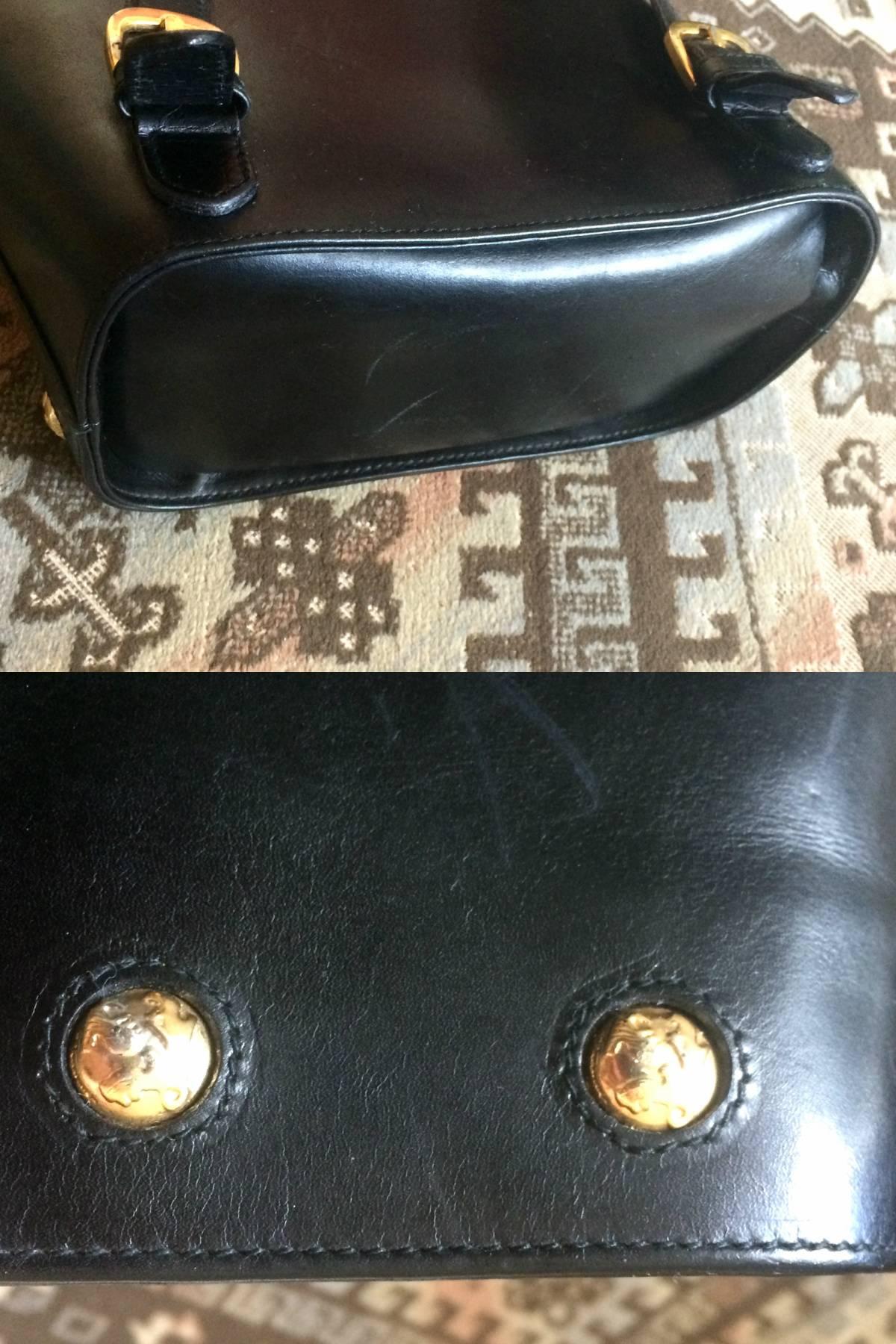 Vintage Salvatore Ferragamo black calf leather backpack with golden motif 1