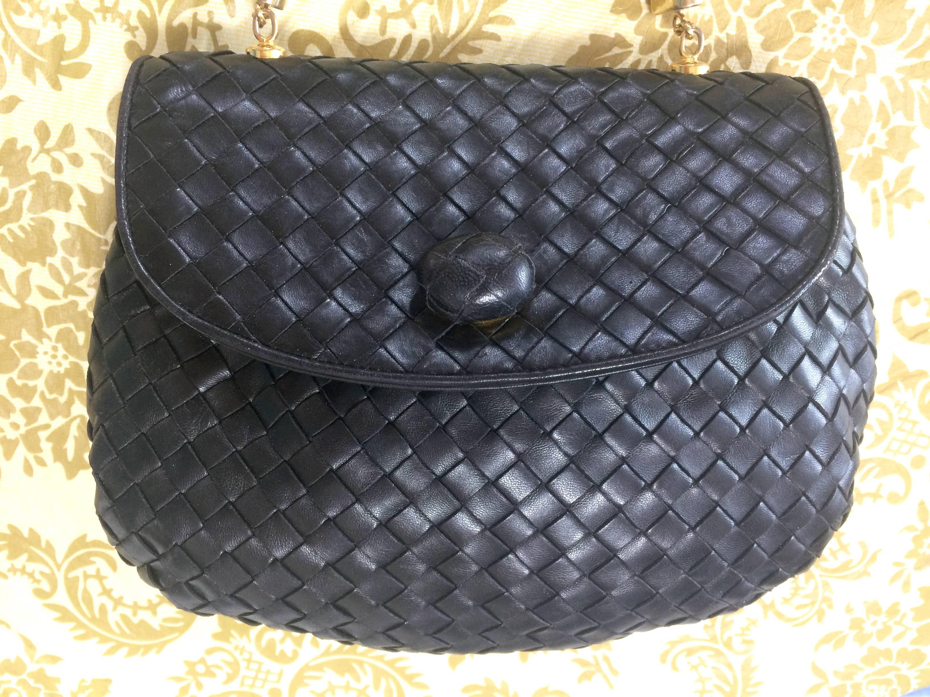 1990s. Vintage Bottega Veneta black intrecciato, woven lambskin handbag with a matching turn-lock closure.

Bottega Veneta's iconic style  intrecciato from early 90's.
The classic black intrecciato bag will make you look absolutely stunning and