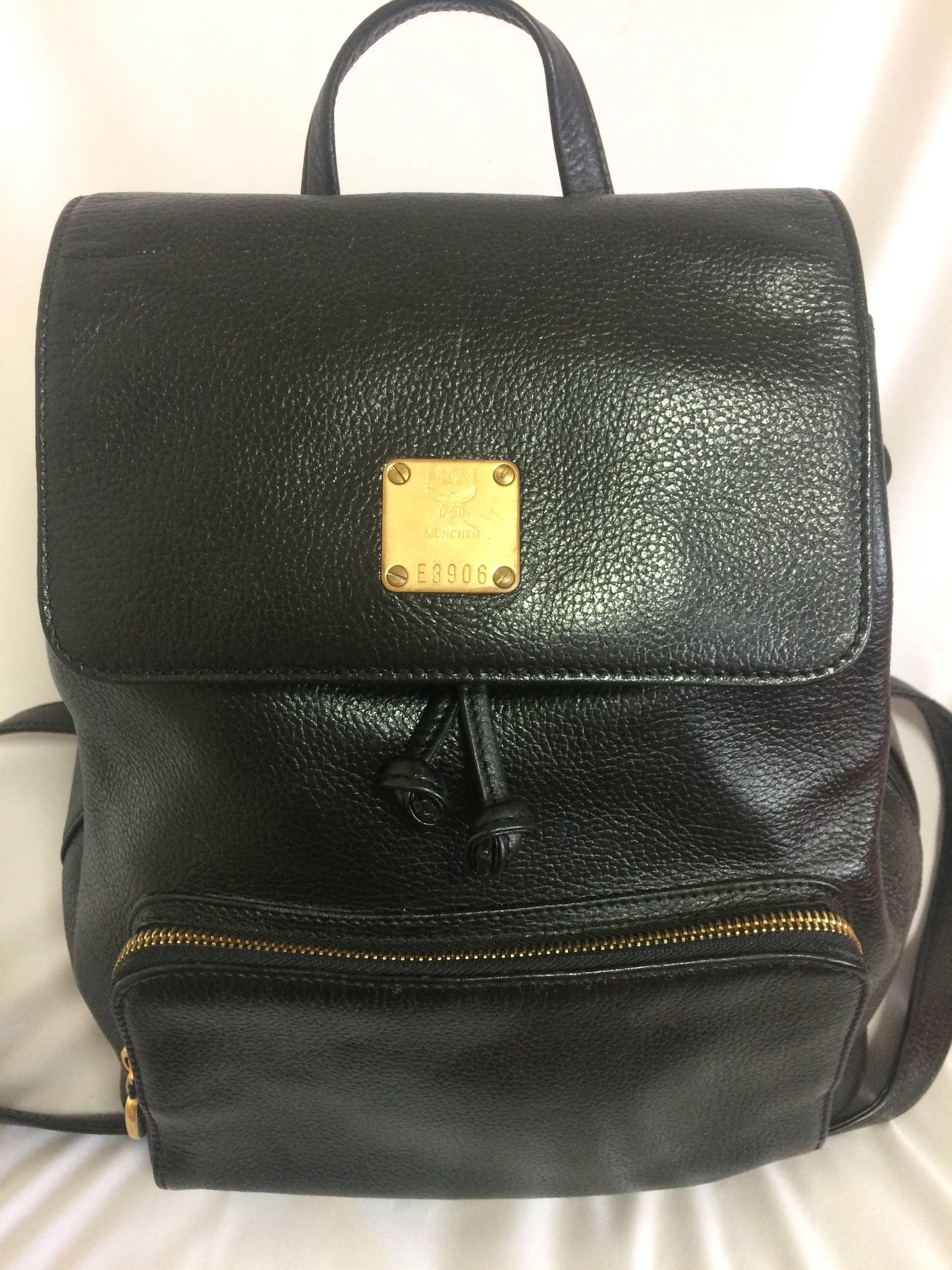1990s. Vintage MCM black leather backpack with golden studded logo motifs. Designed by Michael Cromer. Unisex bag for daily use.

MCM has now come back in trend and so hot in the market!!

This is the vintage MCM black genuine leather backpack from