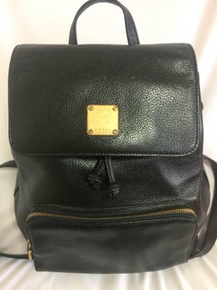 Vintage MCM black backpack with golden studded logos. Designed by Michael Cromer