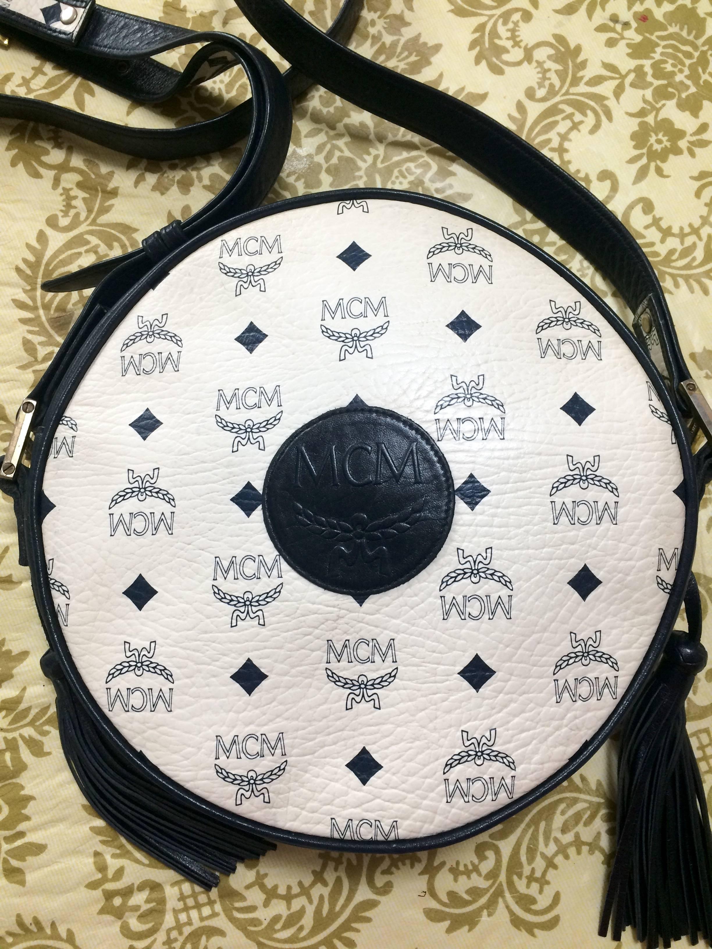 1980s. Vintage MCM navy and white monogram round shape Suzy Wong shoulder bag with leather trimmings. Unisex purse Designed by Michael Cromer.

MCM has been back in the fashion trend again!!
Now it's considered to be one of the must-have designer in