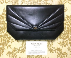 Vintage Nina Ricci black leather chain clutch shoulder bag with a bow stitch