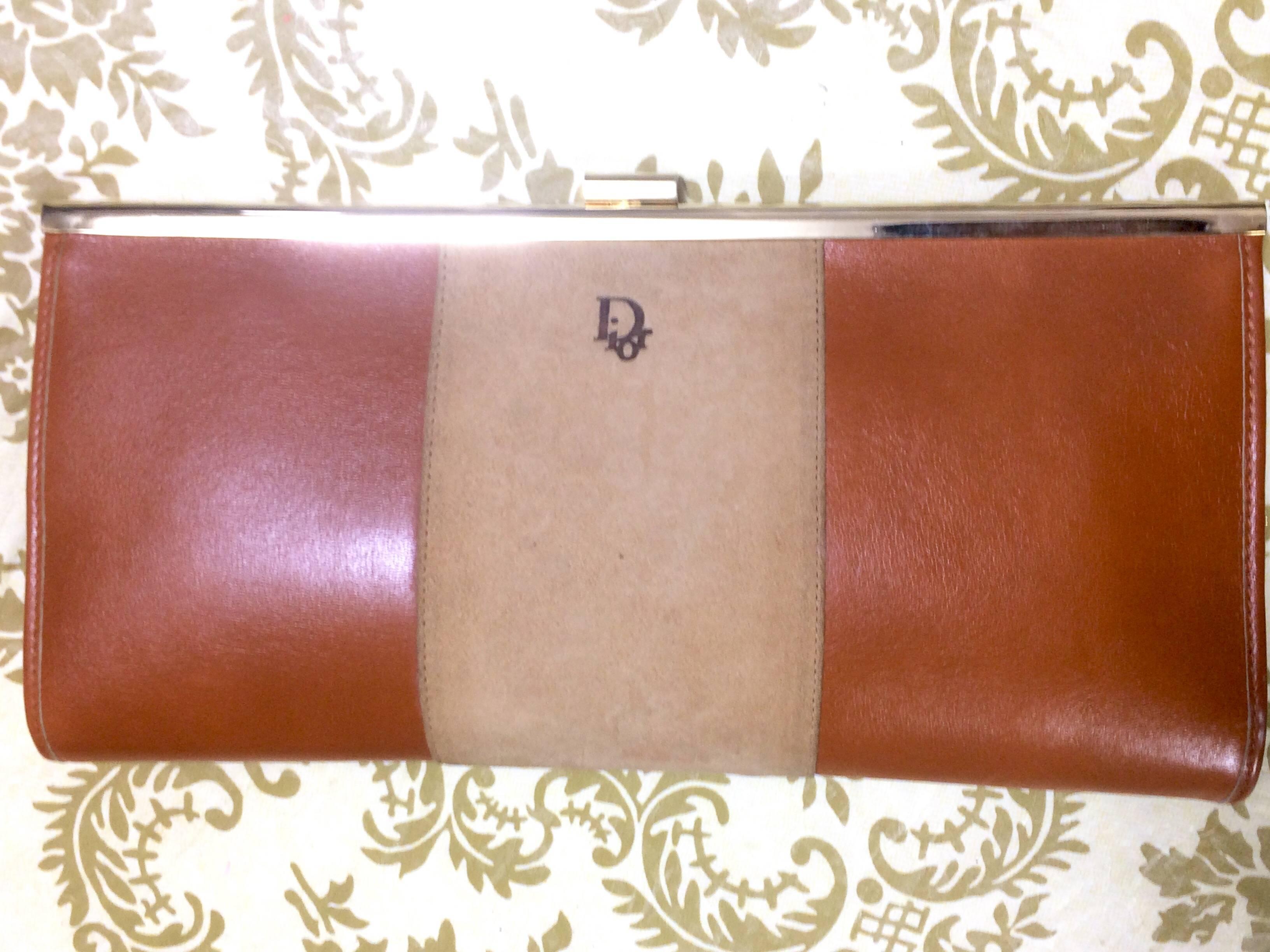 1970's Christian Dior vintage beige suede and tanned brown leather clutch purse with kiss lock closure. Can be a wallet coin wallet or cosmetic pouch. 

Looking classic and elegant! 

This is a Christian Dior vintage leather clutch purse with golden