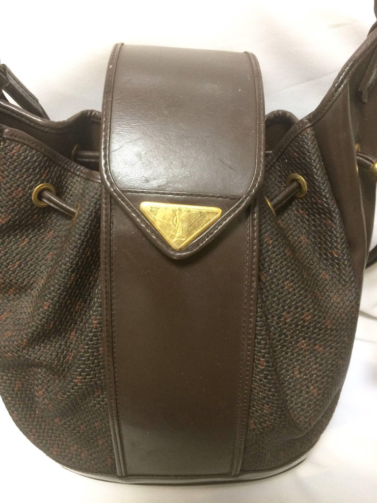 Vintage Yves Saint Laurent brown hobo bucket shoulder bag with golden YSL  motif at 1stDibs | ysl bucket bag, brown ysl bag, ysl drawstring bag