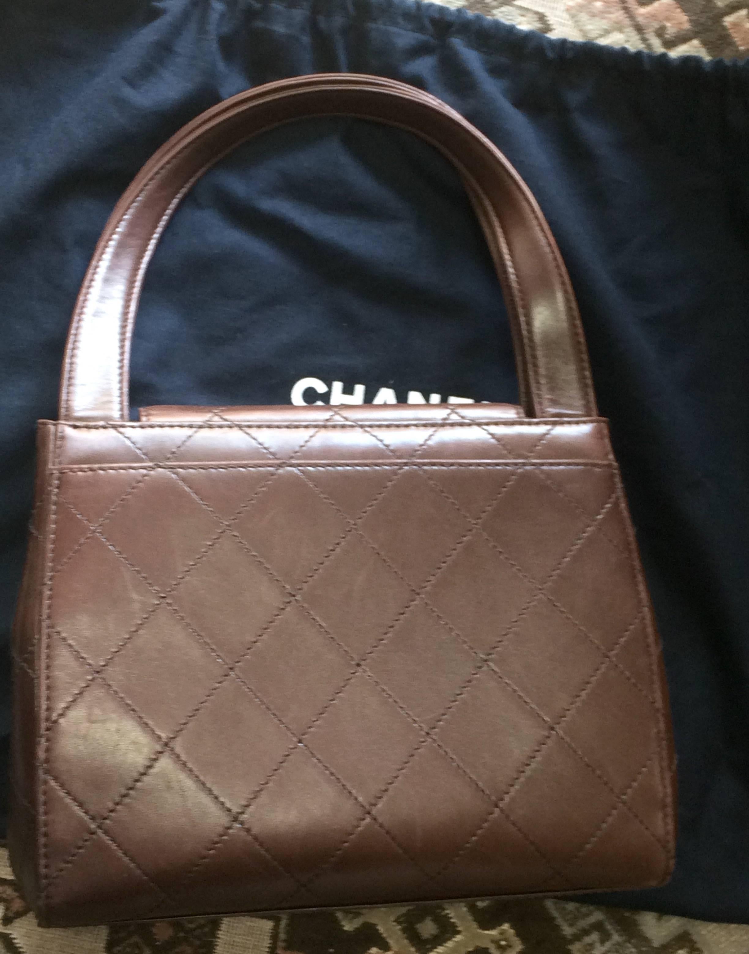 Brown Vintage CHANEL chocolate brown leather trapezoid shape handbag with golden CC. For Sale