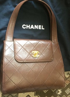 Vintage CHANEL chocolate brown leather trapezoid shape handbag with golden CC.