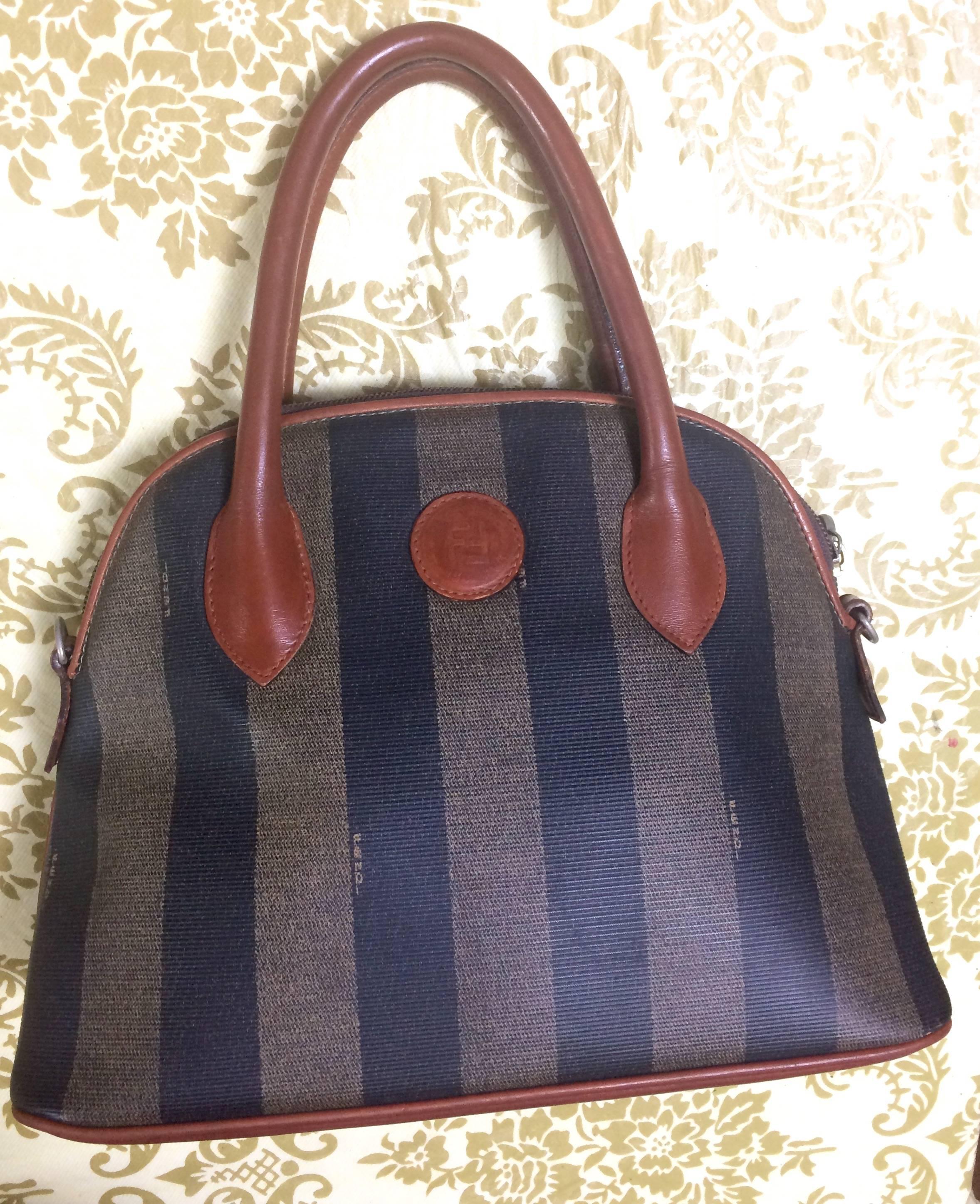 1980s-1990s. Vintage FENDI black and grey pecan stripe bag with brown leather handles and trimmings in bolide shape. Classic daily use purse. 

Here is another FENDI conic pecan pattern handbag in bolide shape from old era. 
Very classic and yet