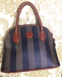 Vintage FENDI black and grey pecan stripe bolide shape bag with brown handles.