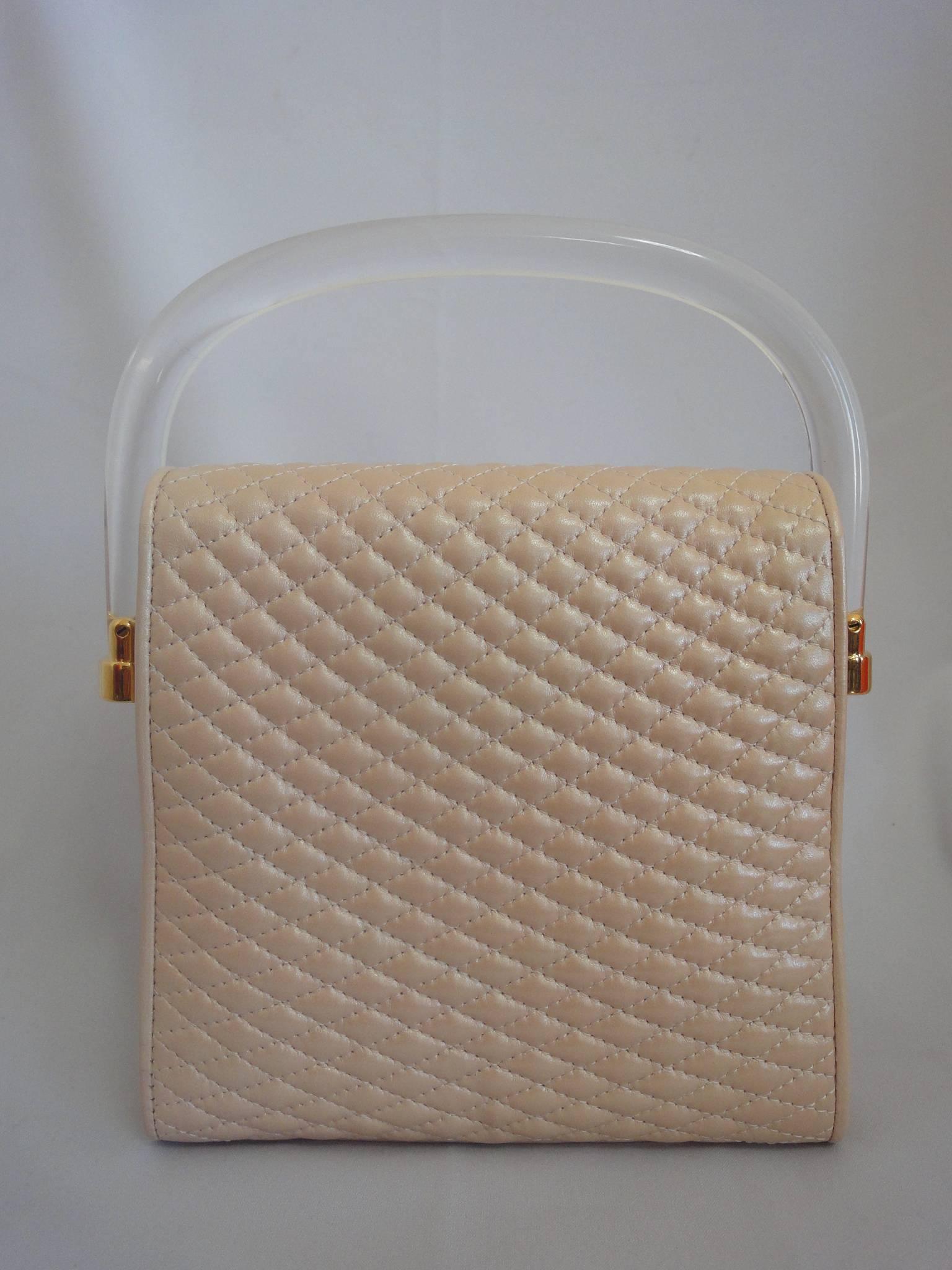 1990s. Vintage Bally pearl pink color lamb quilted leather purse with clear plastic handle with golden logo motif.  Can be shoulder bag.

MINT condition!
Introducing another adorable purse from BALLY back in the early to mid 90's.
Featuring clear