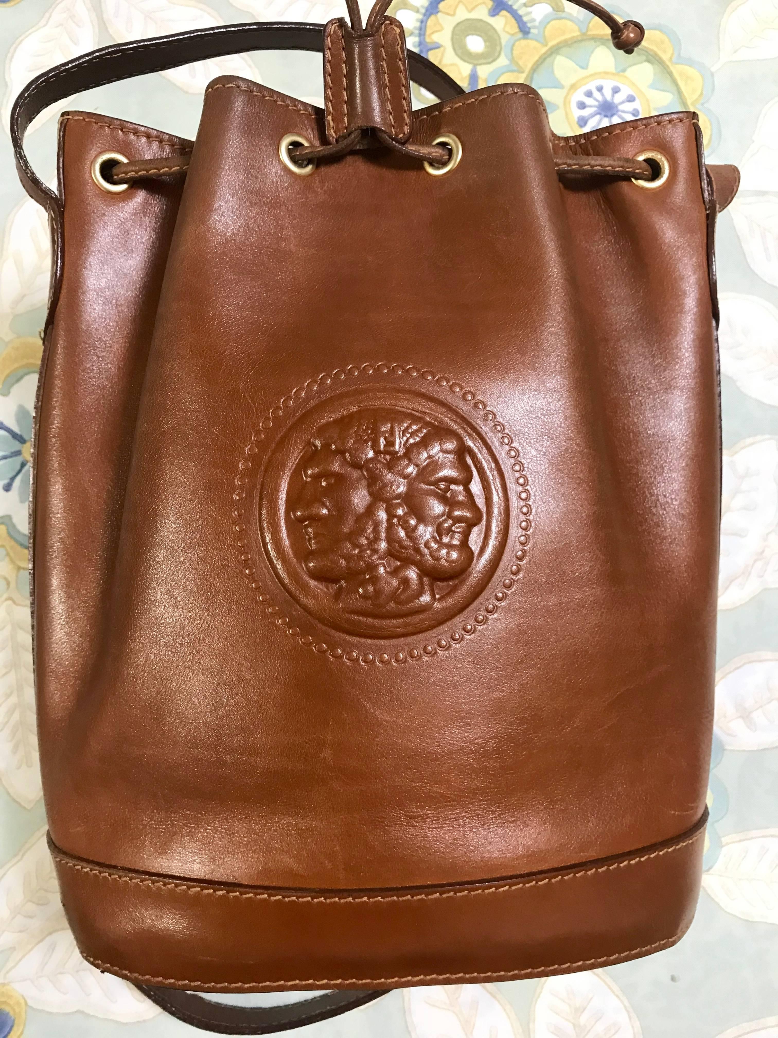 1990s.  Vintage FENDI brown leather hobo bucket, shoulder bag with drawstring and iconic Janus medallion embossed motif at front. Unisex. Rare bag.

If you are a FENDI vintage collector and lover, then this one will be your must-have piece.

This is