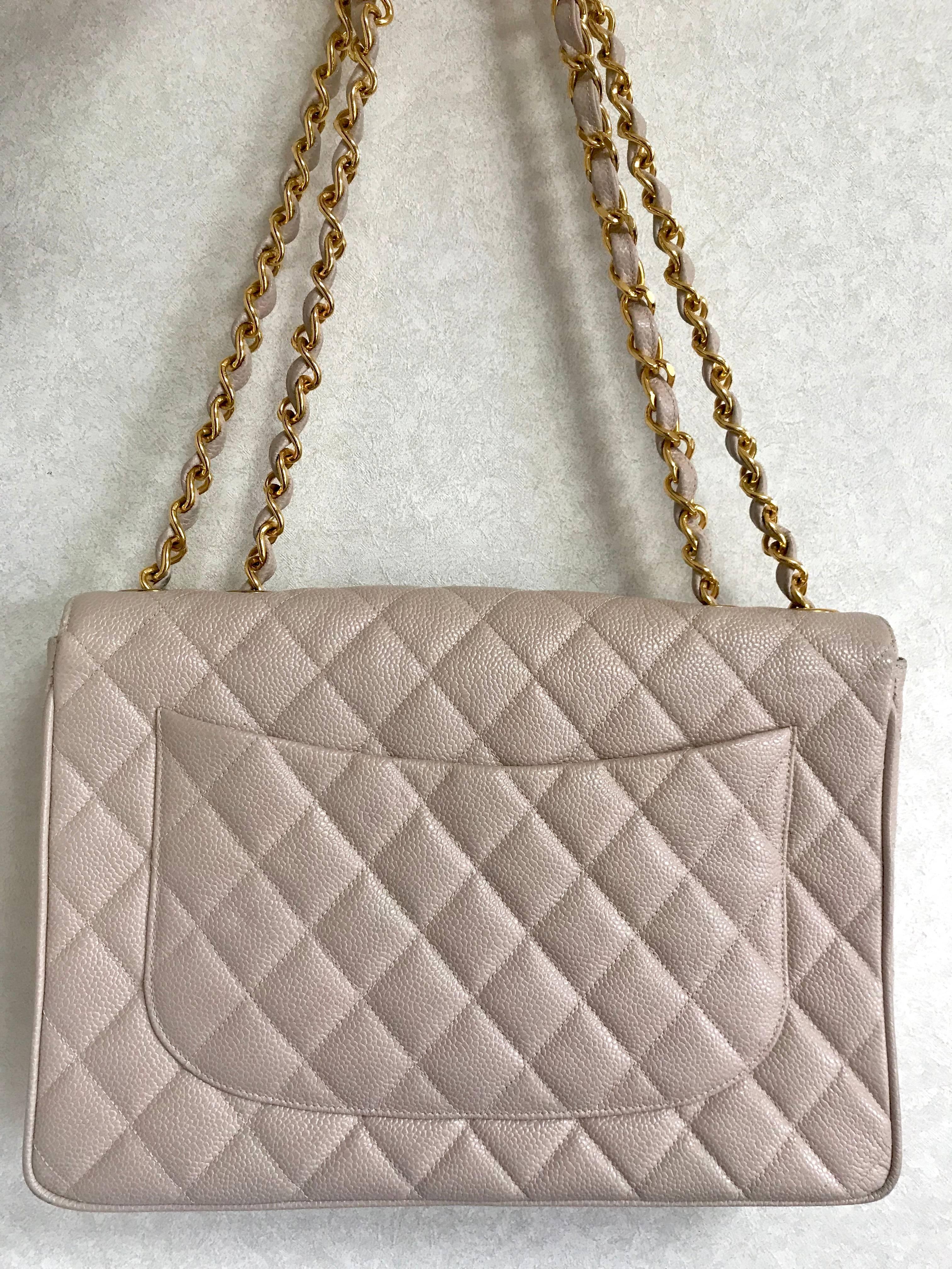 MINT. 1990s. Vintage CHANEL beige jumbo/large 2.55 caviar leather shoulder bag with golden CC motif. Classic purse. Rare color.

Introducing one of the most popular and classic masterpiece bags from CHANEL back in the 90's, a jumbo/large size double