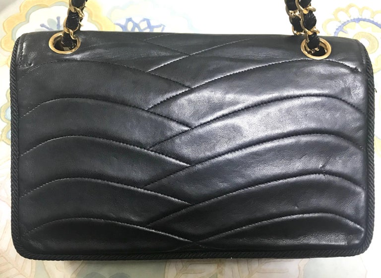 Chanel Vintage black 2.55 shoulder bag with wavy stitches and rope strings.  For Sale at 1stDibs