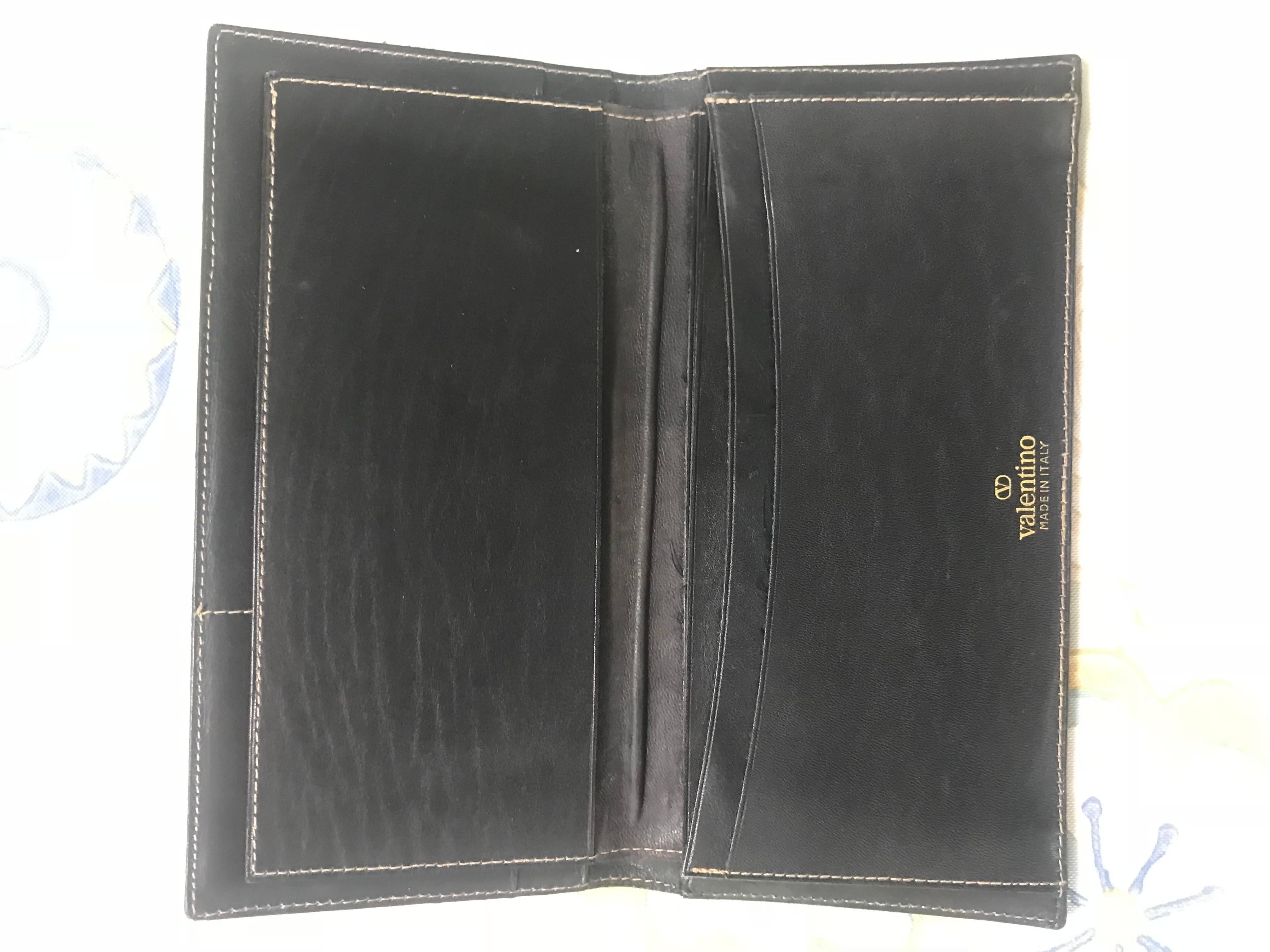 Women's or Men's Vintage Valentino black leather long wallet with beige stitches and V logo.
