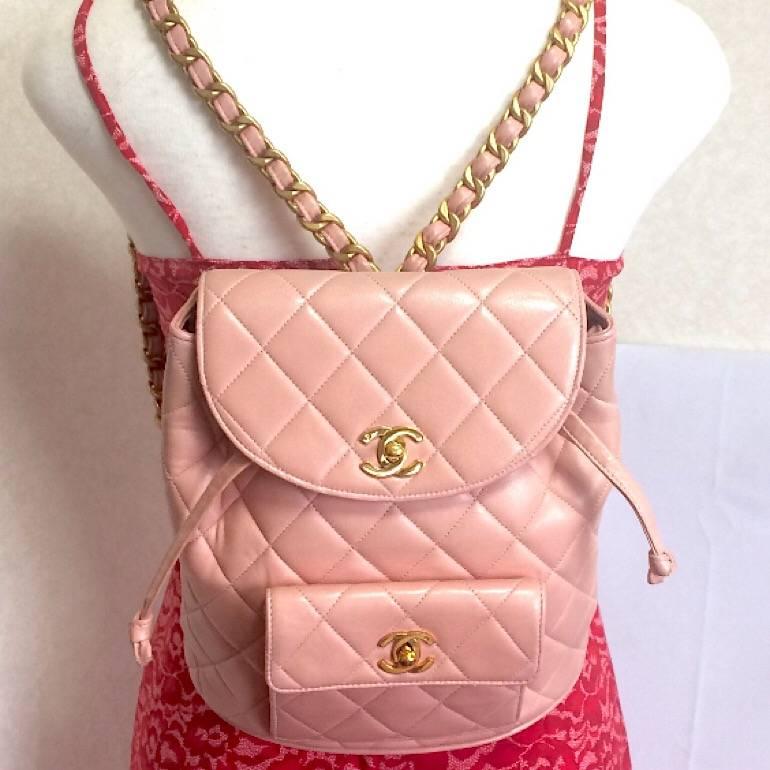 Beige Vintage CHANEL quilted pink lamb backpack with golden CC and chain straps.