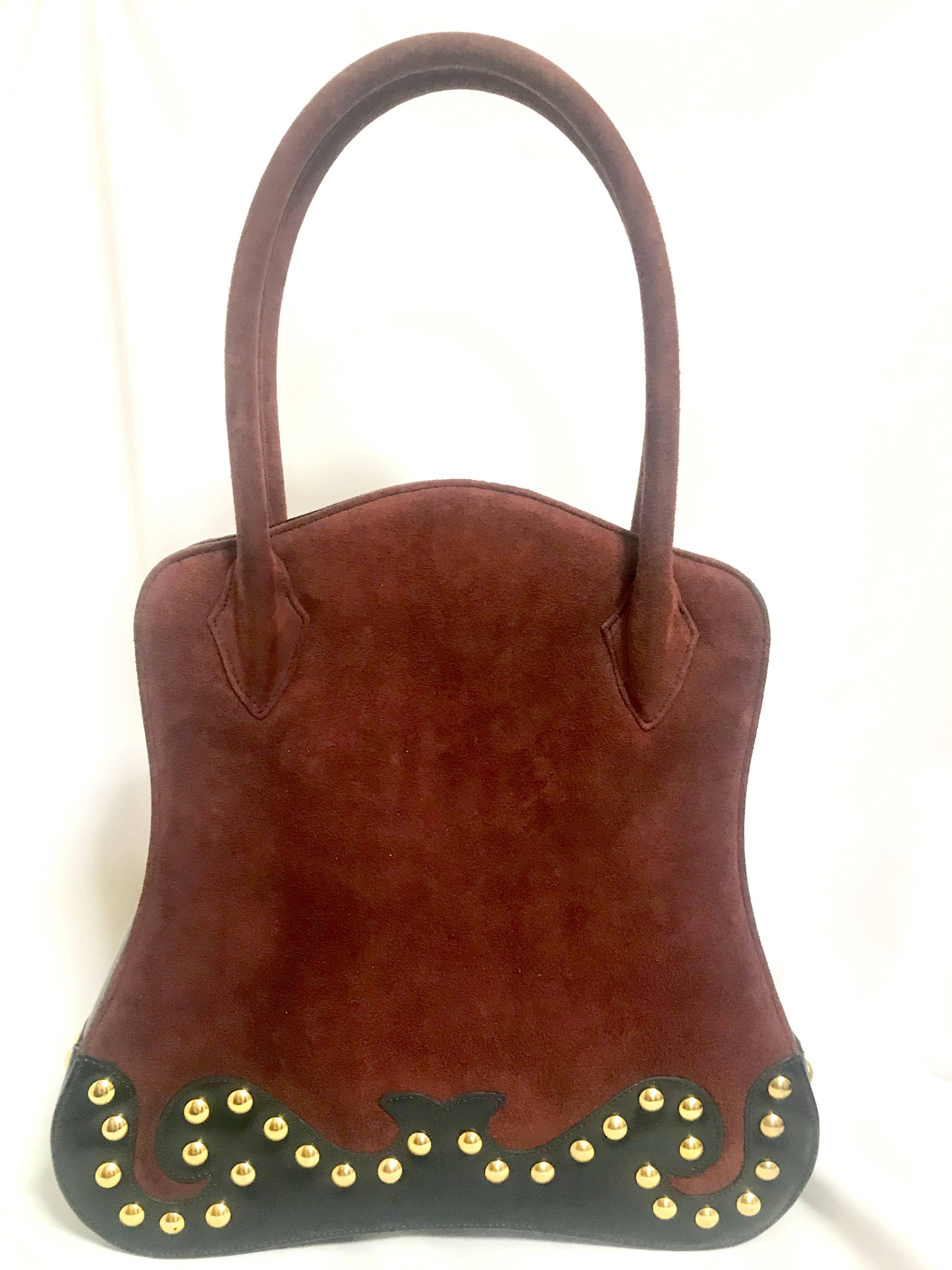 1990s. Vintage Christian Lacroix genuine wine brown suede and black leather sexy feminine shape bag with golden logo motif and studs.  Hot purse.

Here is another beautiful and rare piece from Christian Lacroix back in the 90's. 
Genuine wine brown