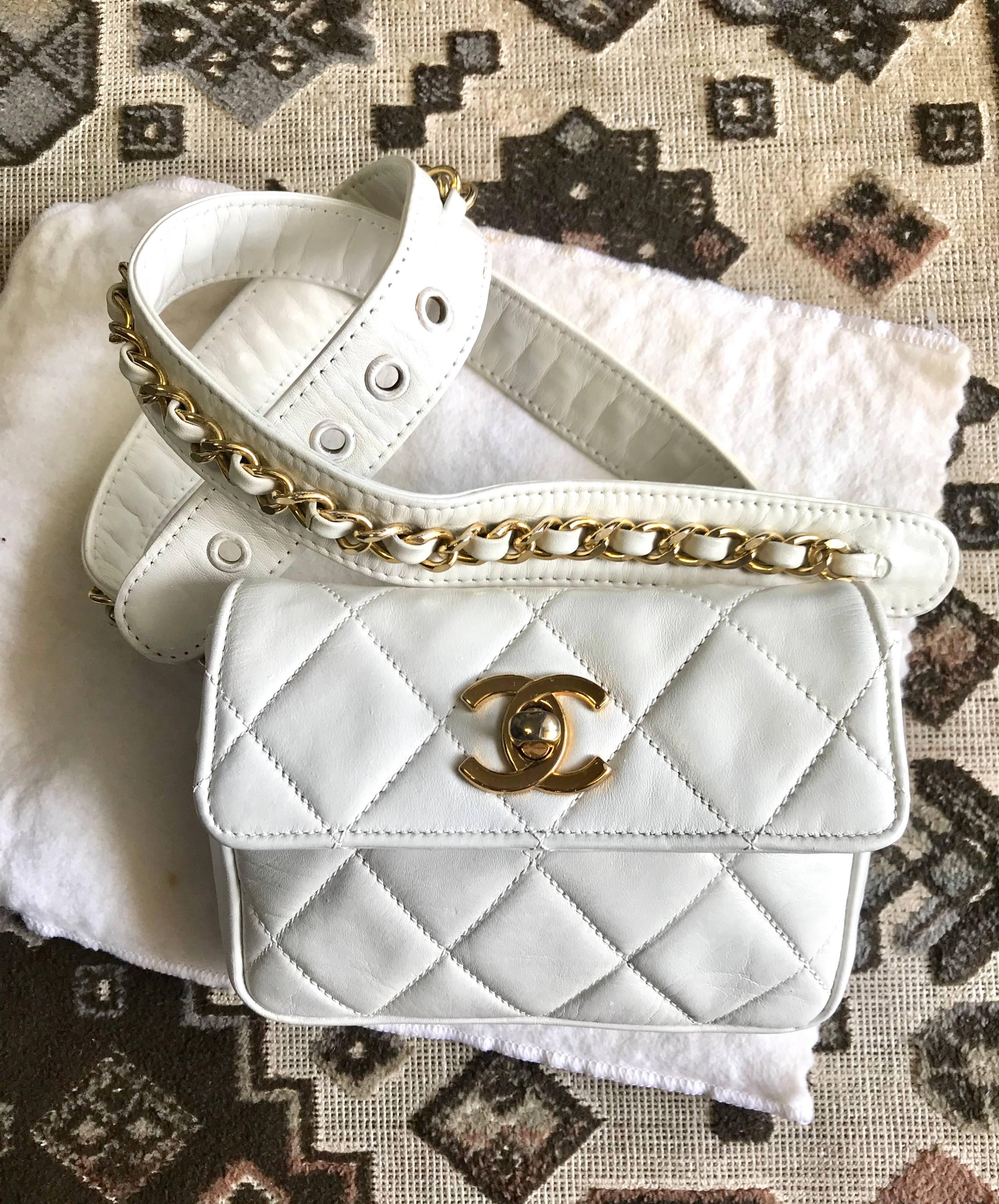 1980s. Vintage Chanel white leather waist purse, fanny pack, hip bag with gold CC closure and chain belt.  Good for waist size 30
