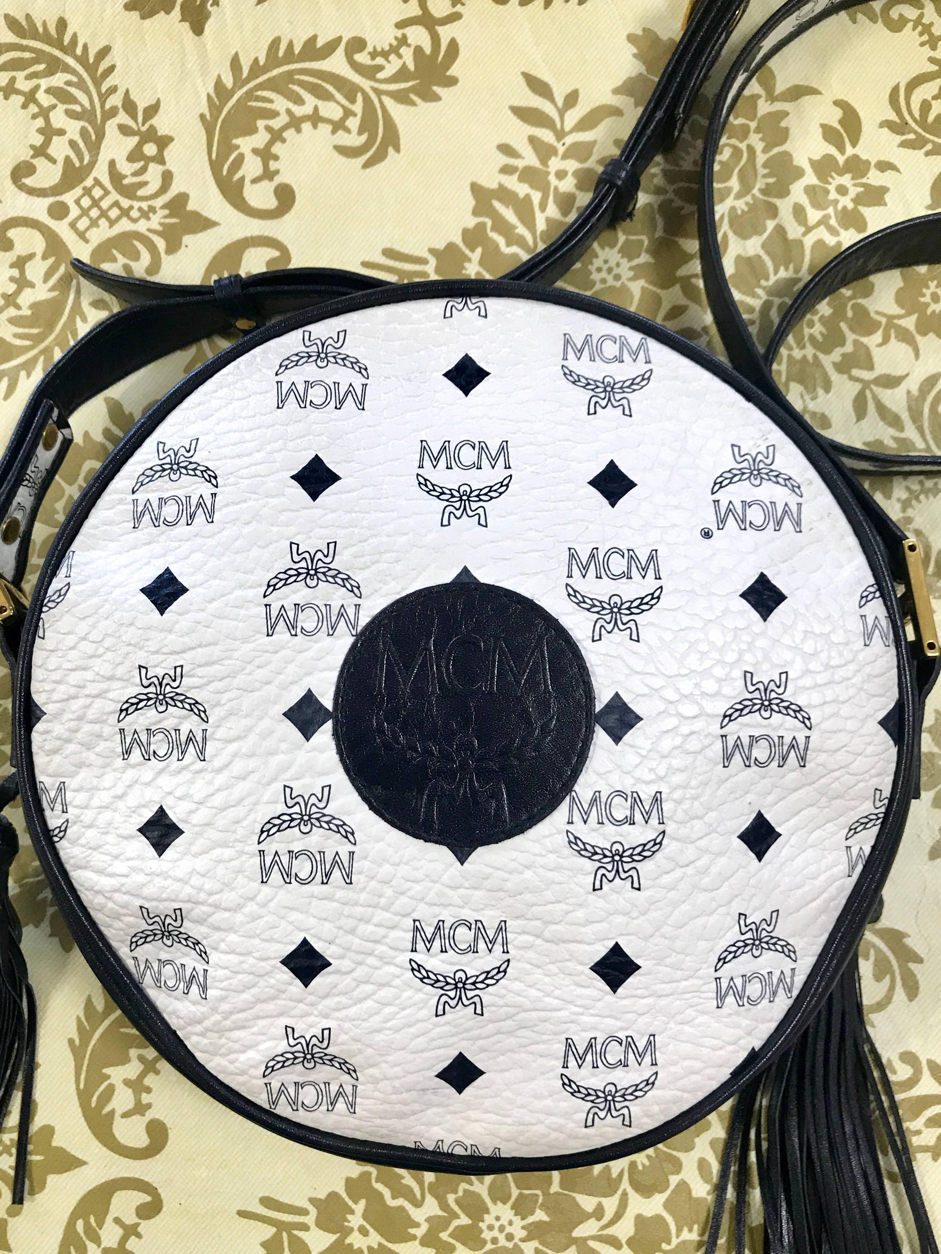 Beautiful vintage condition! 
1990s. Vintage MCM navy and white monogram round shape Suzy Wong shoulder bag with leather trimmings. Unisex purse Designed by Michael Cromer.

MCM has been back in the fashion trend again!!
Now it's considered to be
